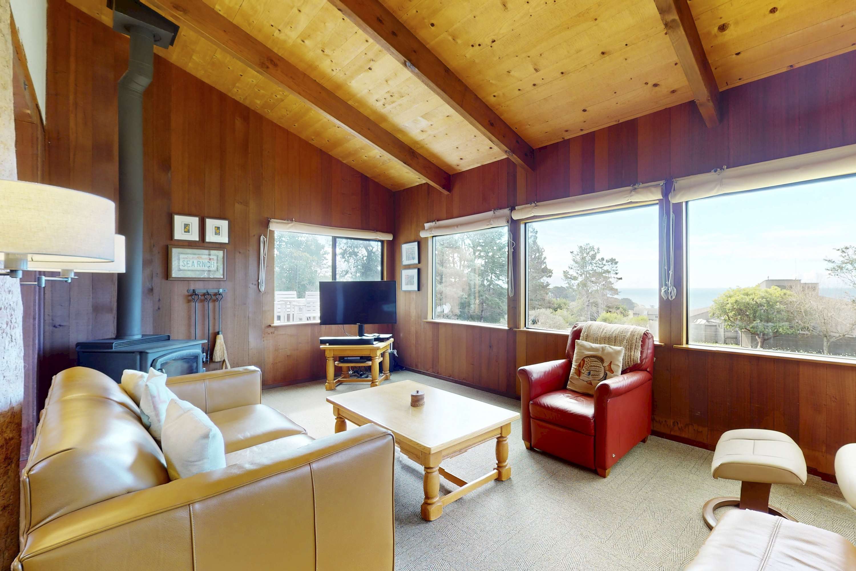 Morning light floods this cozy living space, inviting you to relax and enjoy ocean views from every angle.