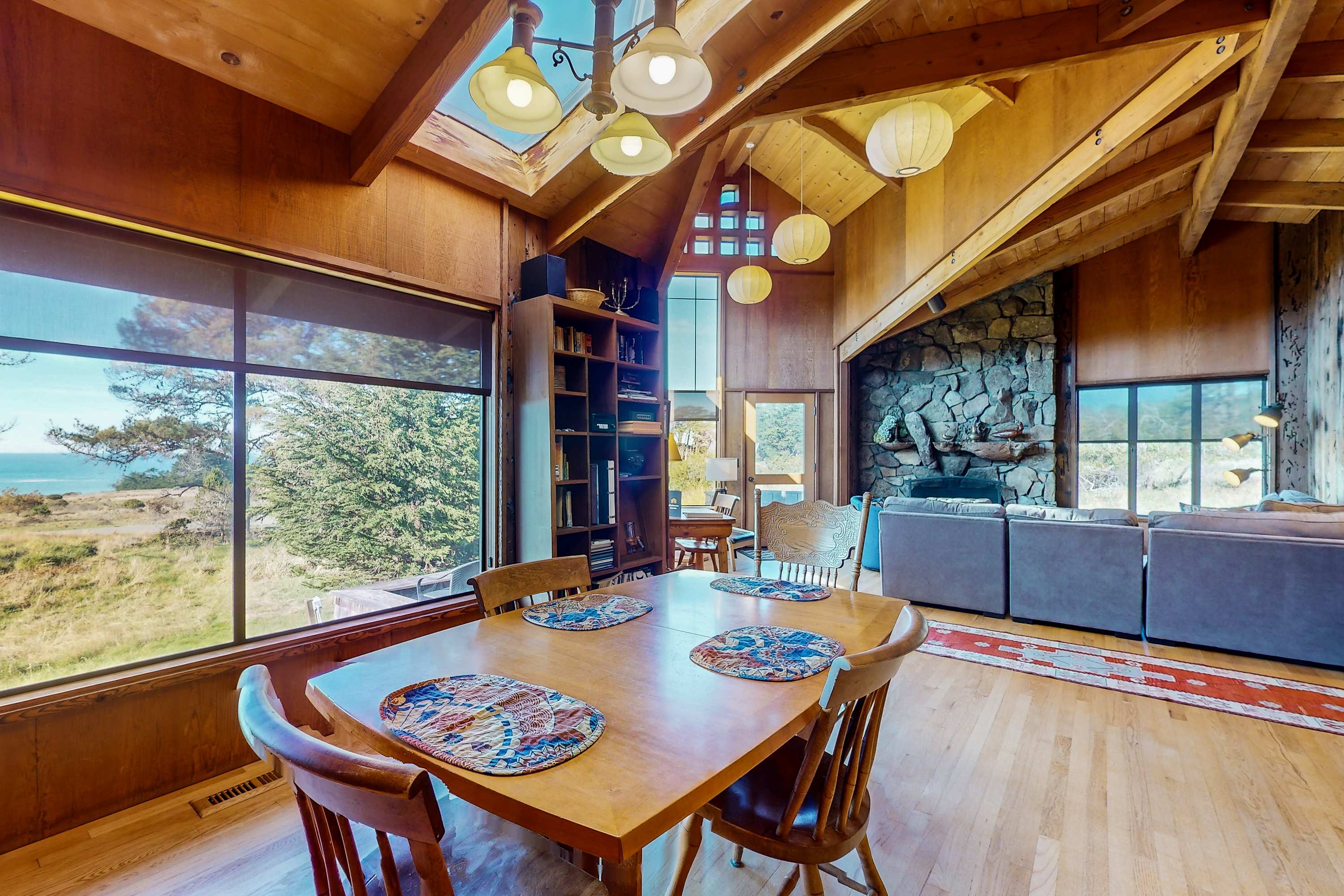 Dine in style as you watch the sunset through expansive windows, making every meal a memorable experience in this inviting space.