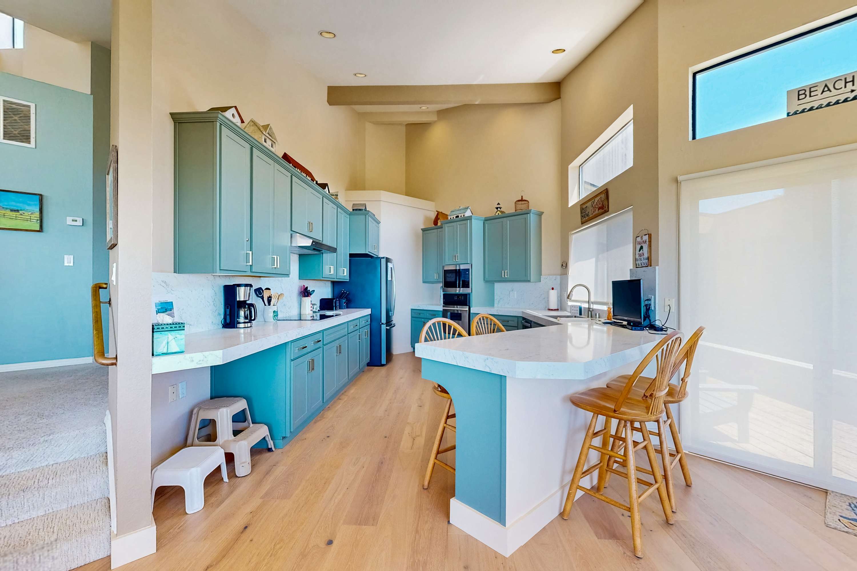 Cook up coastal delights in this bright kitchen, designed for culinary creativity with stunning ocean views as your backdrop.