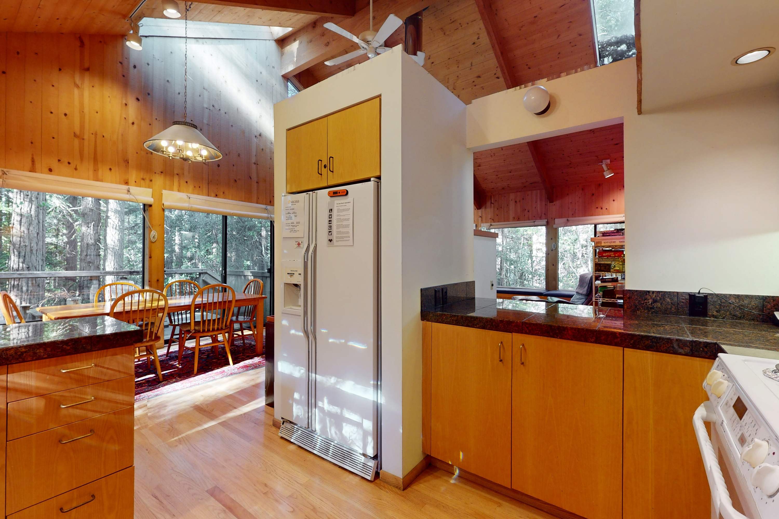 An open design of the kitchen flows seamlessly into the dining area, making it easy to entertain while enjoying the forest views.