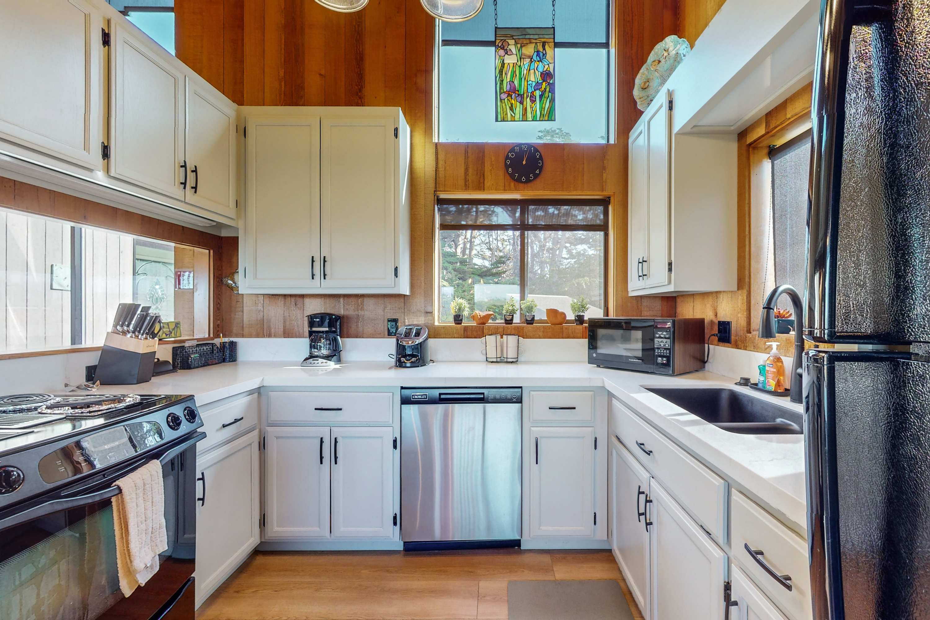 Cook culinary delights in this well-equipped kitchen, where natural light pours in, making meal prep a joyful experience.