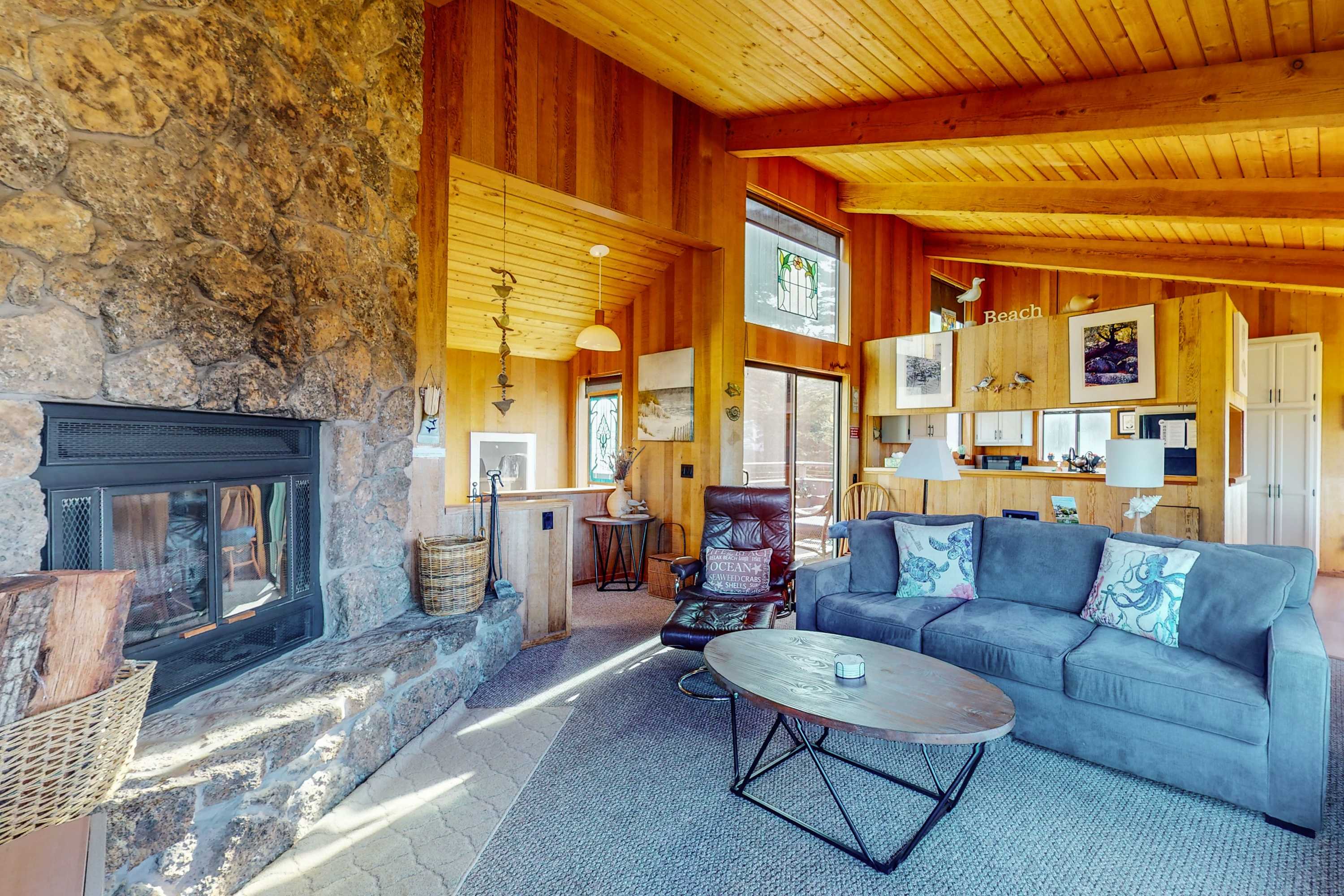 Gather around the inviting living room, where the warmth of the stone fireplace enhances your evenings spent with loved ones.