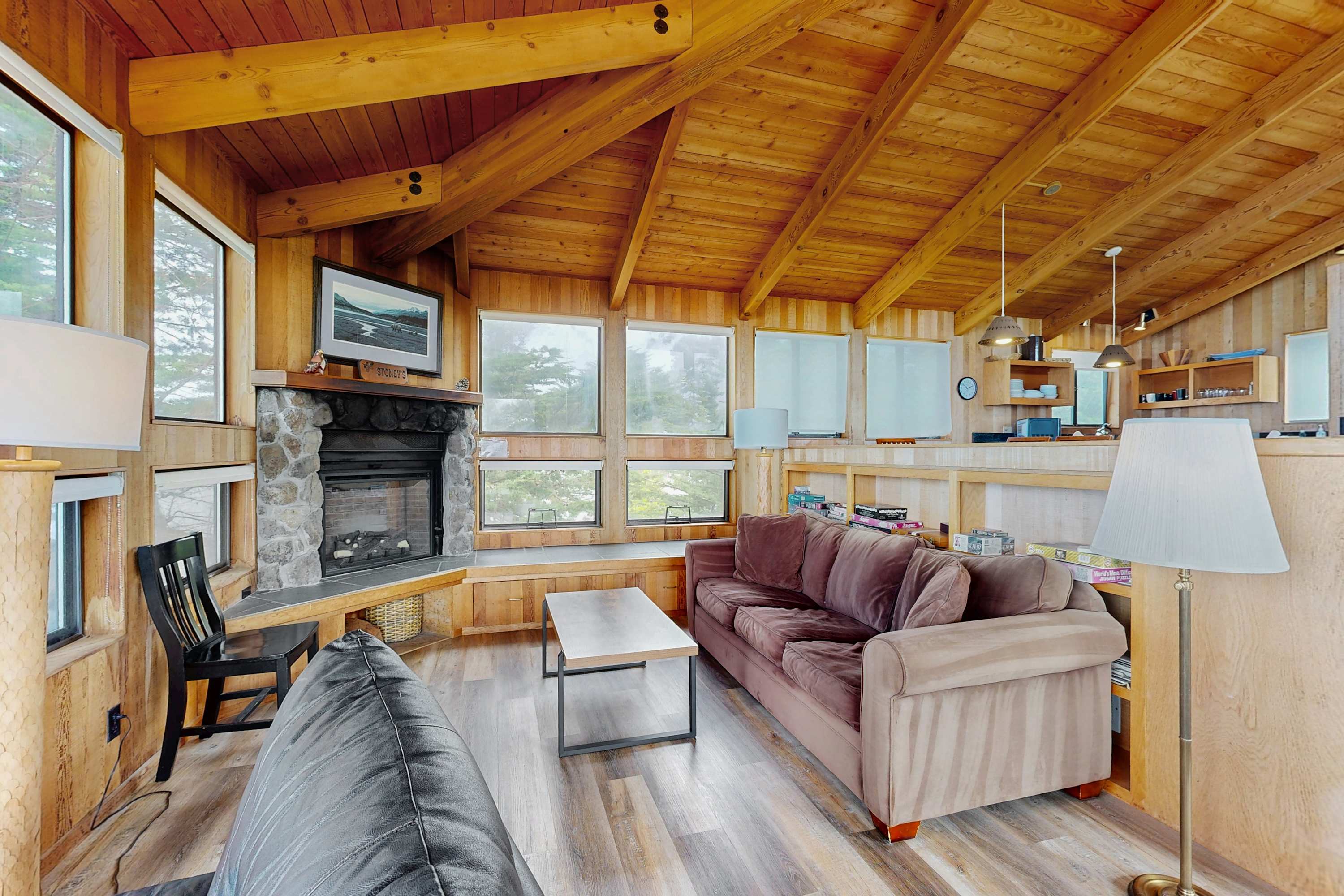 Gather around the stone fireplace in this inviting space, ideal for cozy evenings spent with loved ones.
