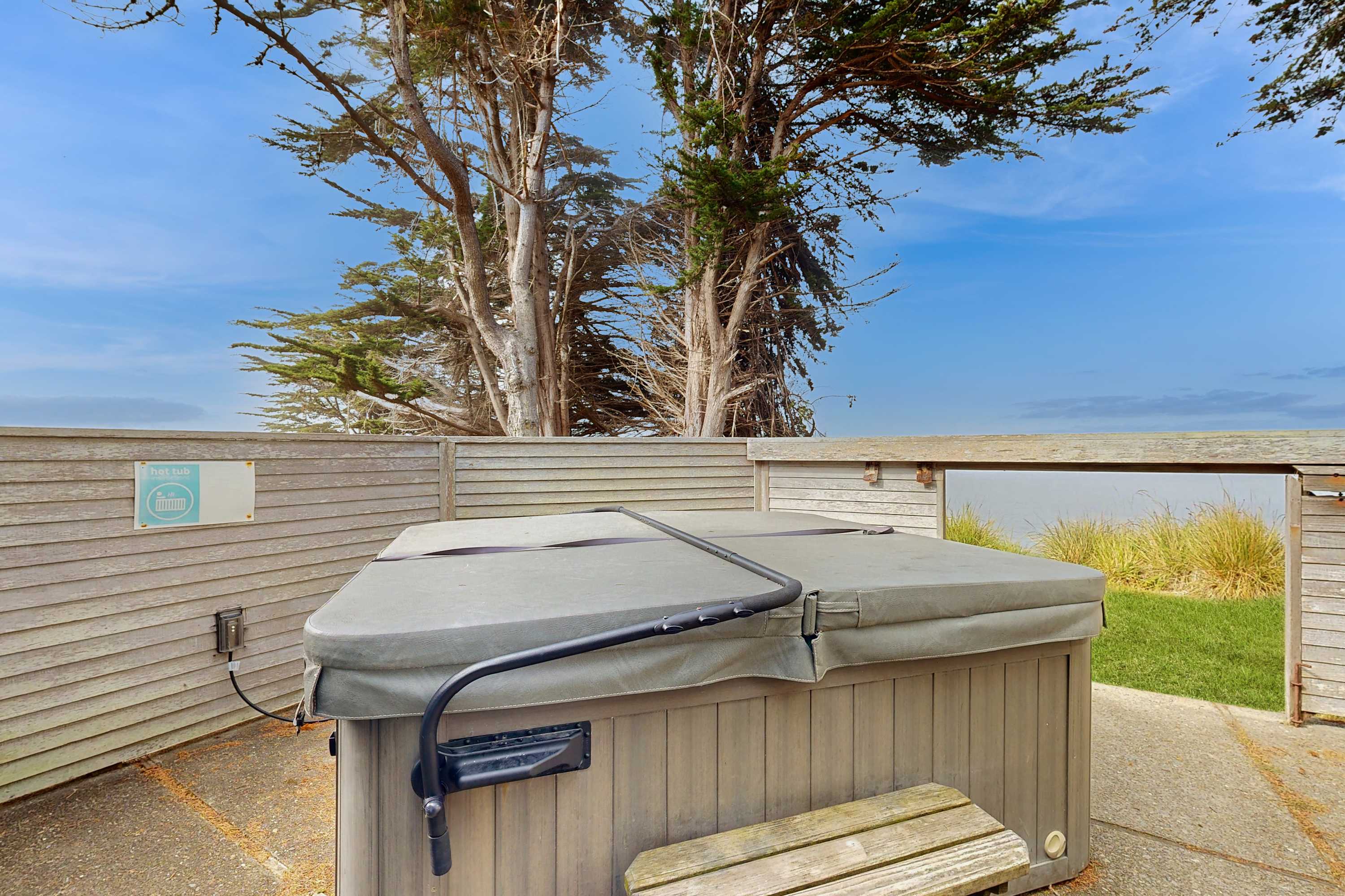 Indulge in a soak under the stars in your private hot tub, the ultimate way to unwind after a day of seaside adventures.