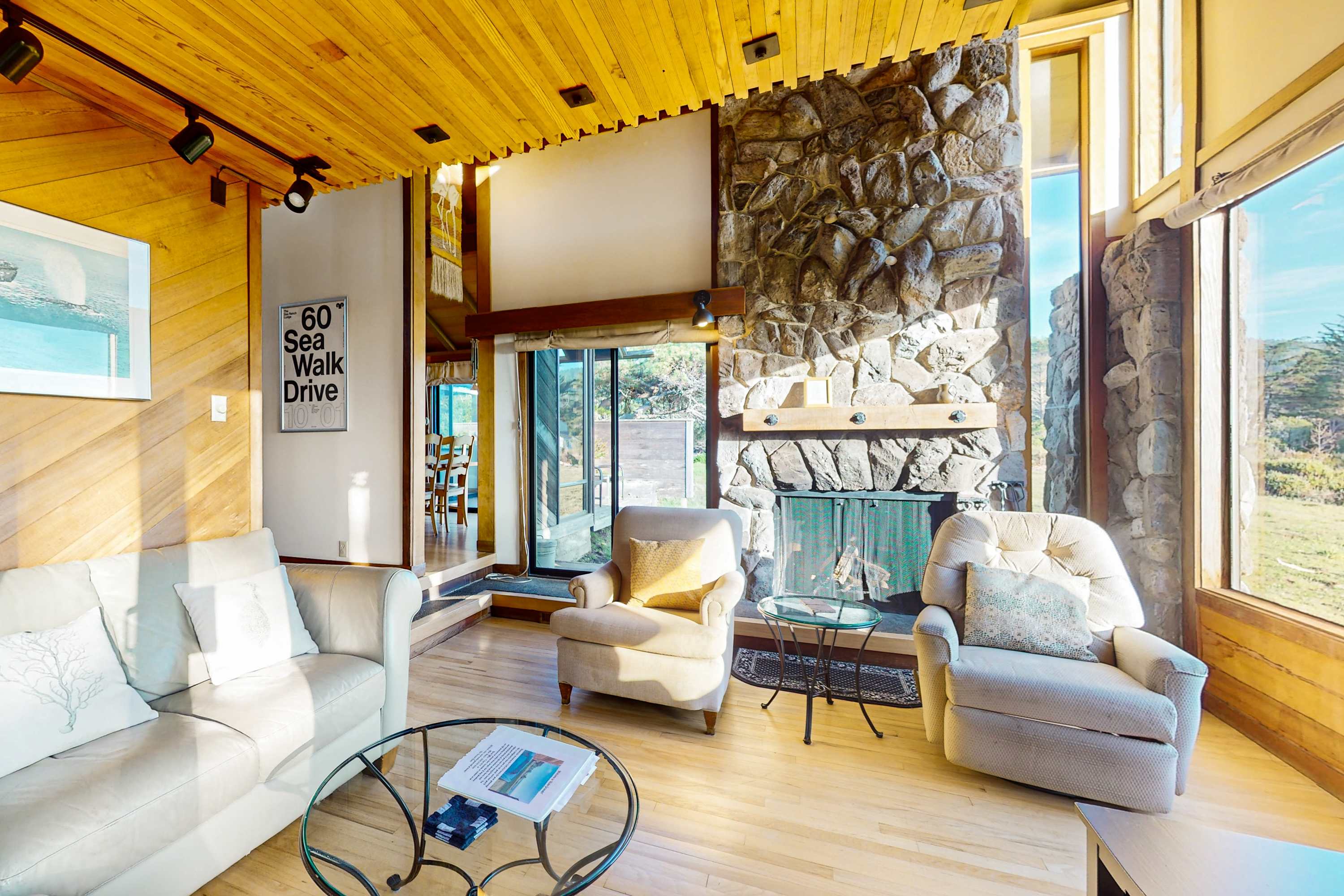 Gather around the stunning stone fireplace in this spacious living area, ideal for sharing stories after a day of adventure.