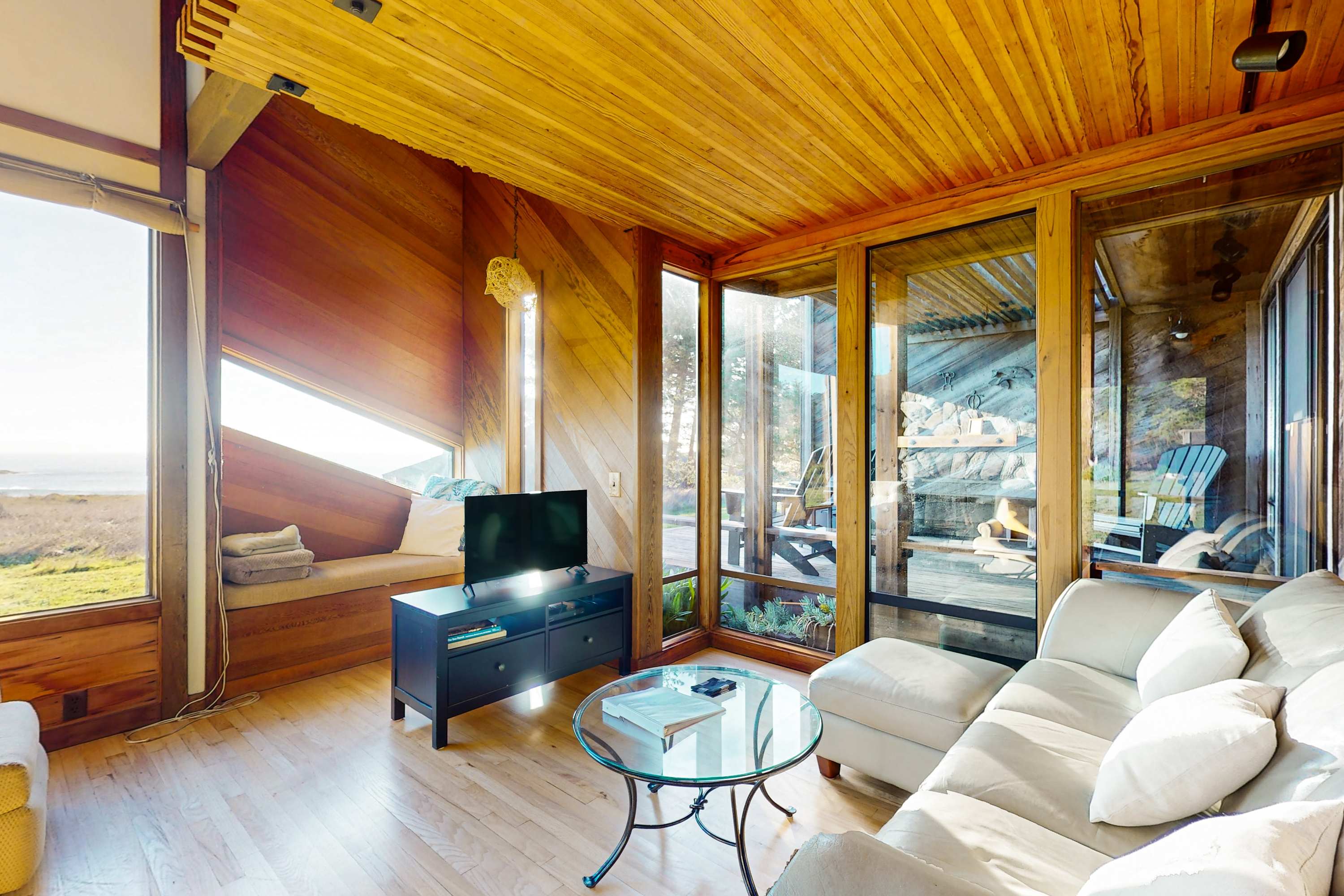 Natural light floods the living room, creating a warm and inviting atmosphere perfect for cozy evenings by the wood-burning fireplace.