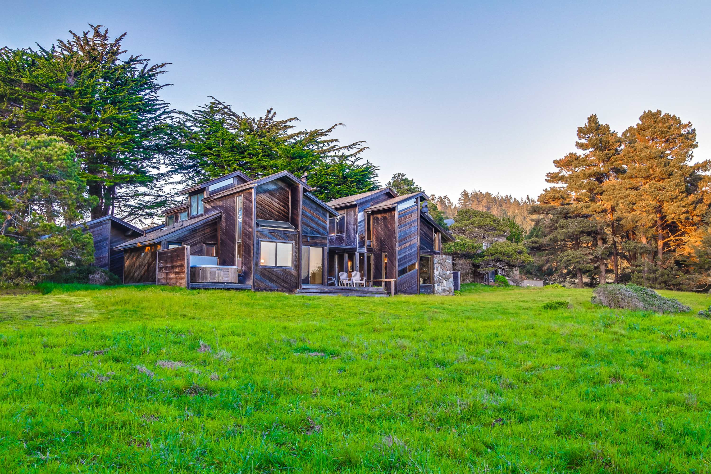 Admire the unique architecture of your coastal retreat, harmoniously blending with the lush surroundings for a truly immersive Sea Ranch experience.