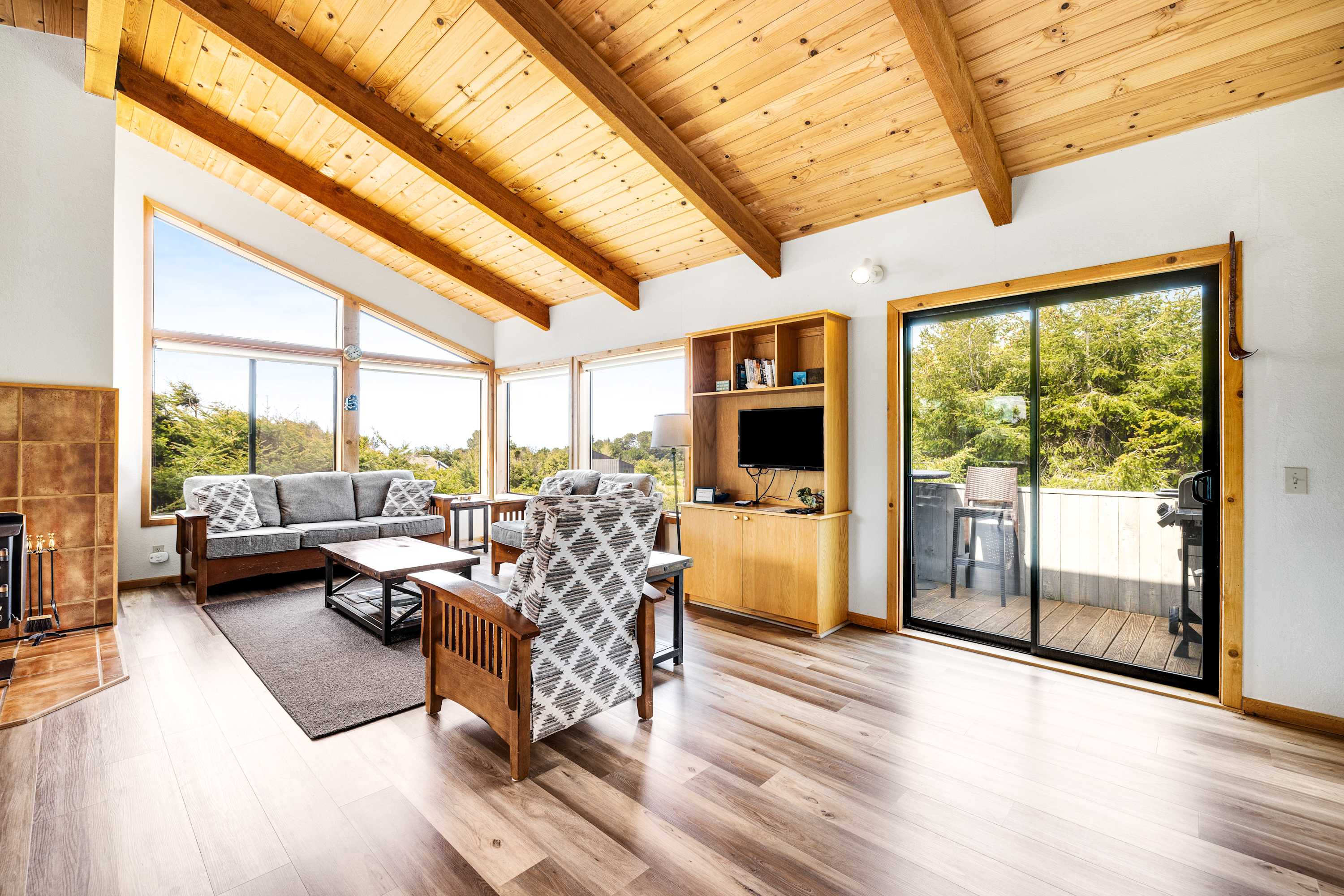 Morning light fills the living room, inviting you to unwind with a book or enjoy a cozy chat with loved ones in this inviting space.