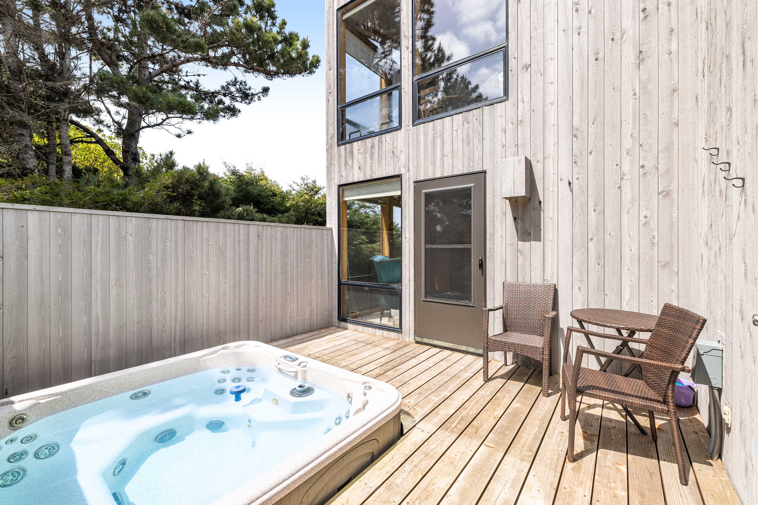 Savor the soothing bubbles of your private hot tub, where relaxation meets nature in this tranquil outdoor retreat.