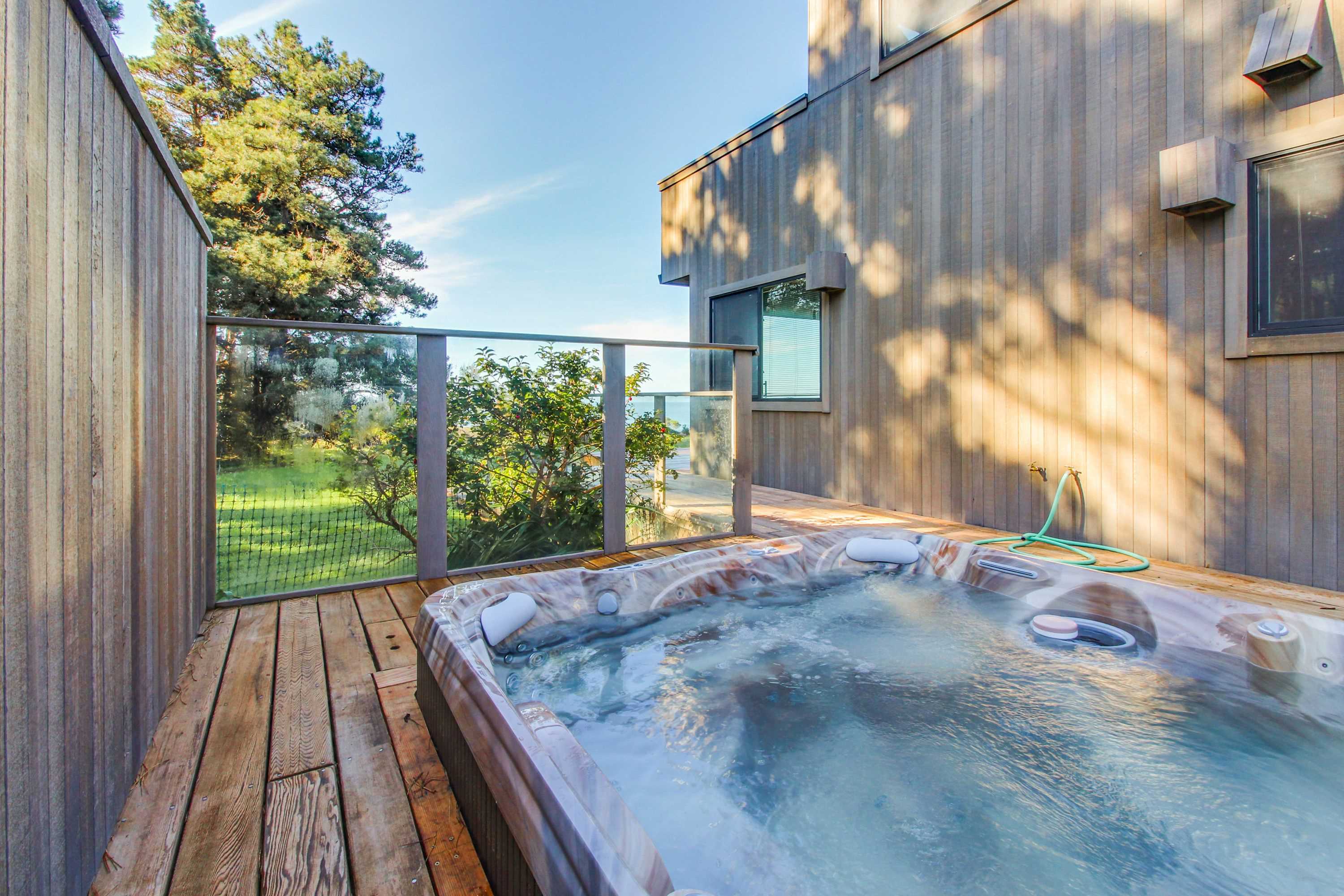 Sink into relaxation in your private hot tub, where every soak offers a chance to unwind while enjoying the coastal scenery.