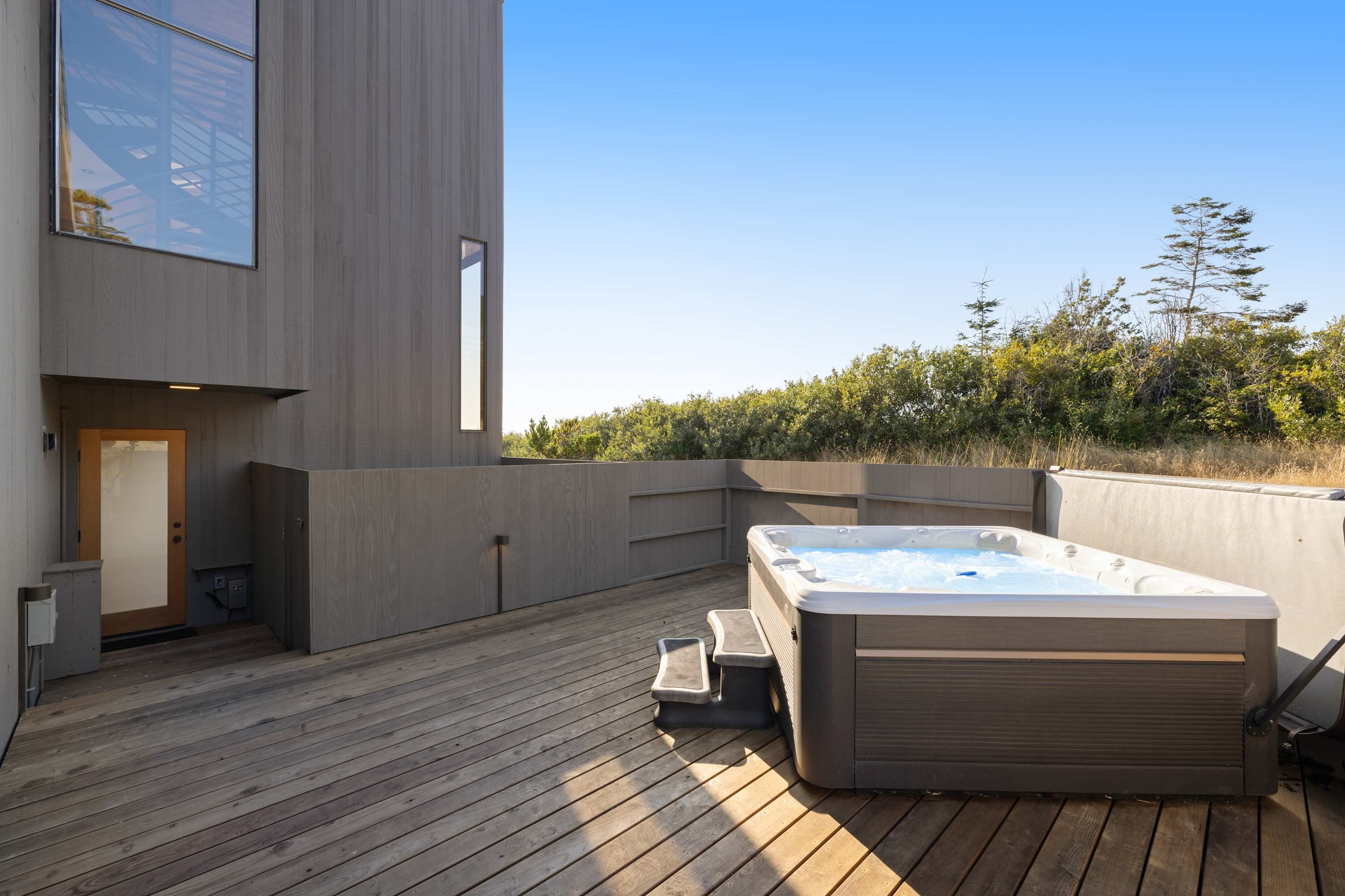 Step outside to your private hot tub, where you can soak under the stars and let the ocean breeze wash your cares away.