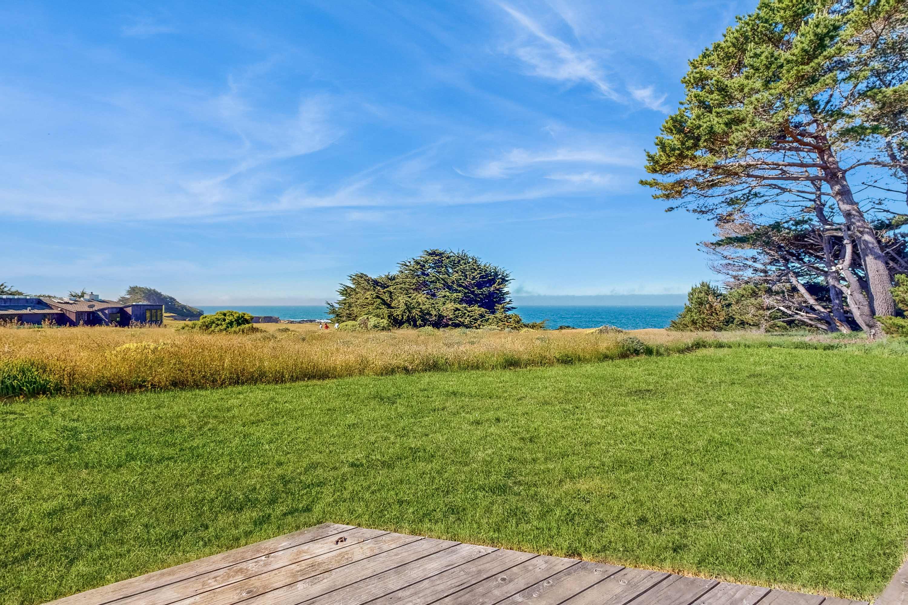 Gaze across the vibrant landscape to the endless ocean, a soothing sight that invites you to explore the nearby beaches.