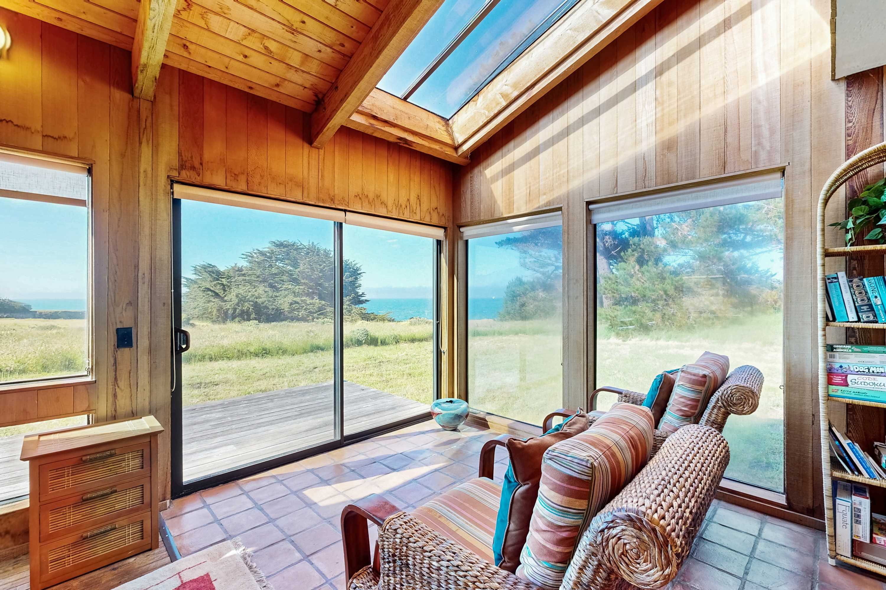 Bask in the inviting living room, where the expansive windows frame breathtaking ocean views, perfect for cozy evenings or lively gatherings.