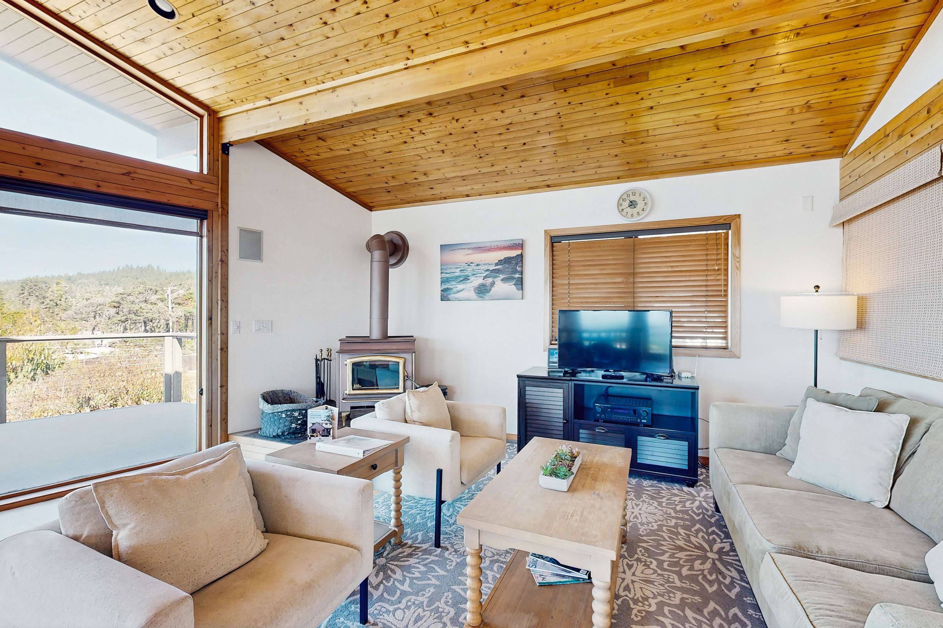 Gather around the cozy living room, where natural light floods in, creating a warm space for relaxation and connection.
