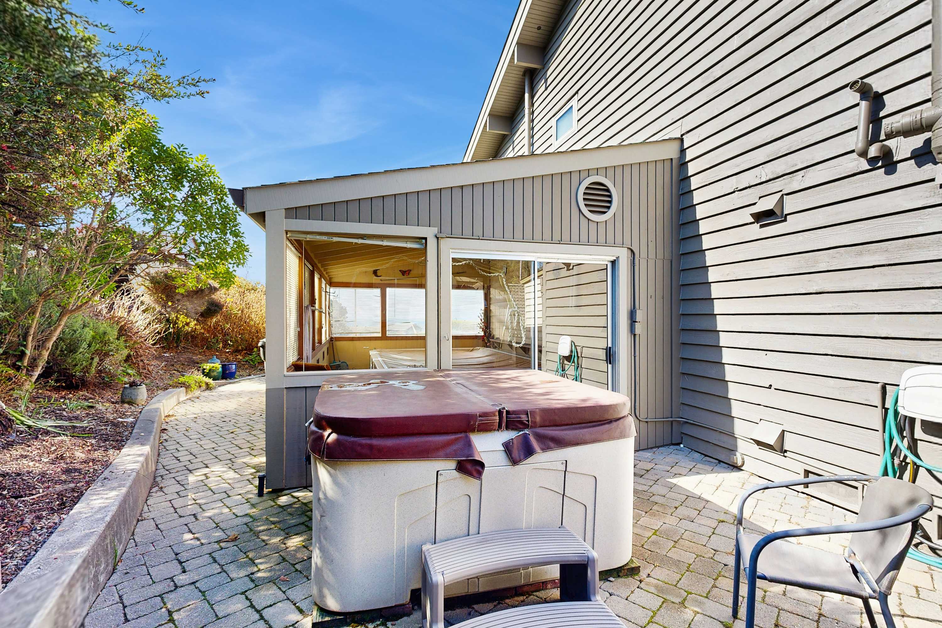Sink into relaxation in the private hot tub, surrounded by serene coastal views—your personal oasis awaits.