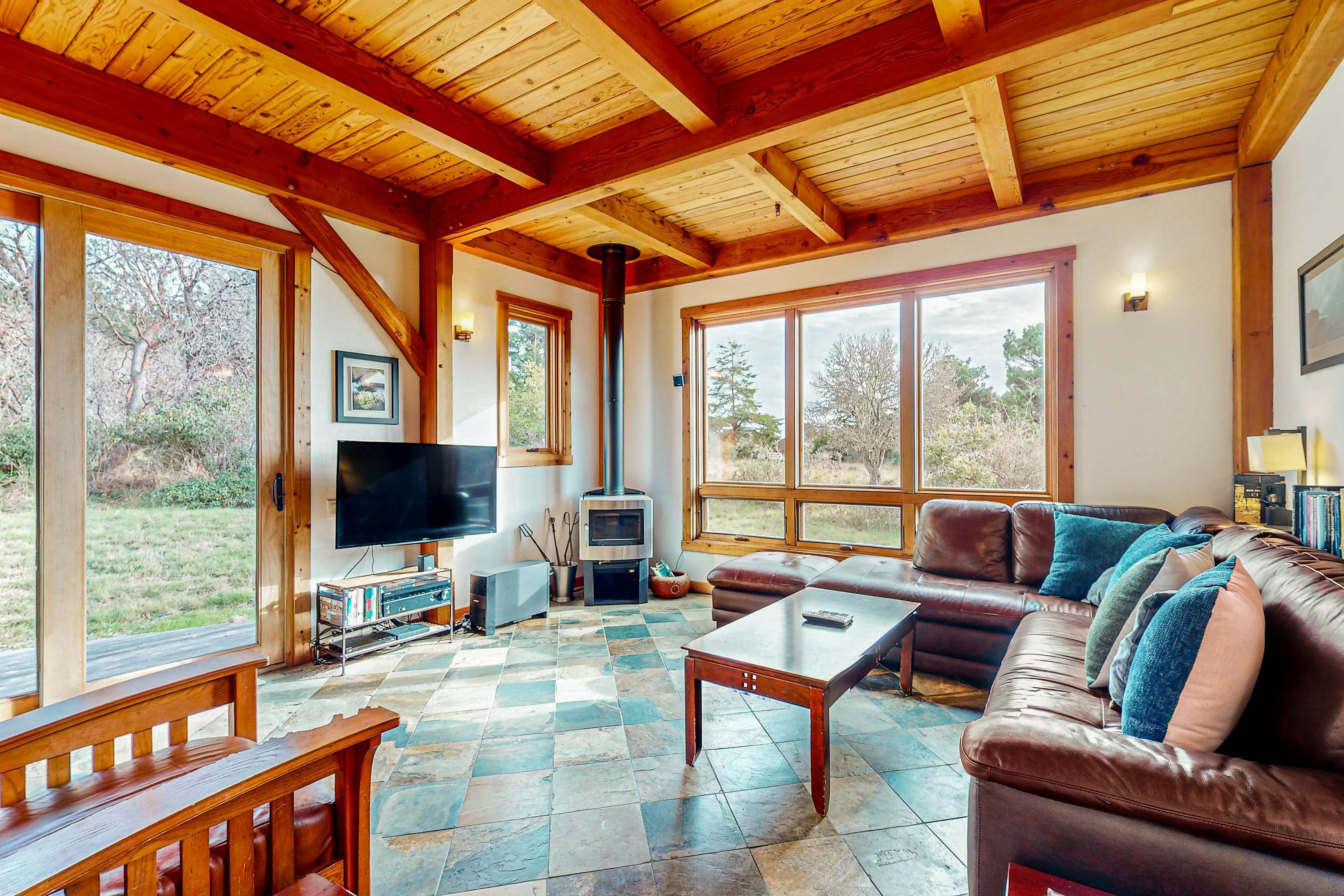 With cozy seating and a wood-burning fireplace, this living room invites you to unwind after a day of adventure, all while soaking in the peaceful atmosphere.