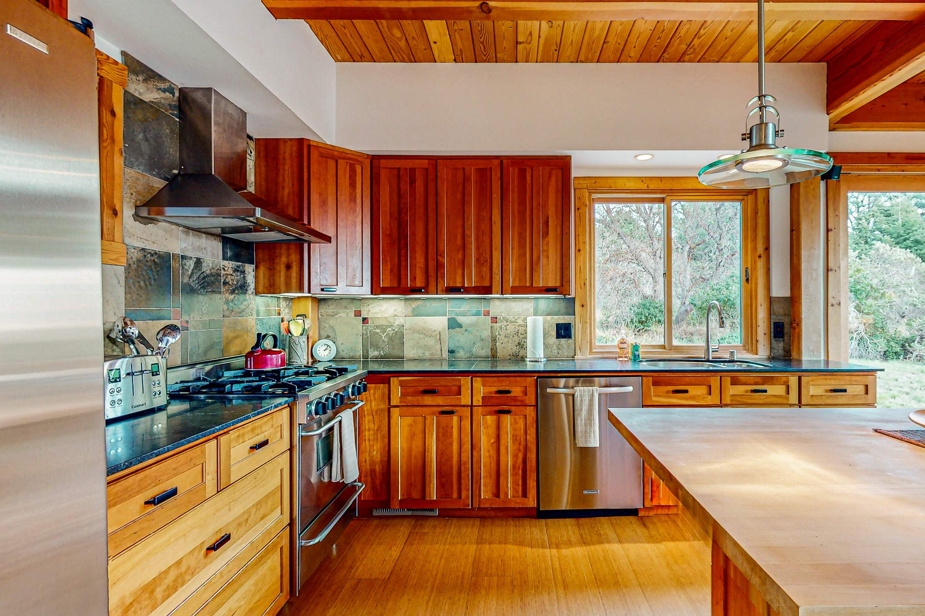 Your culinary creations come to life in this well-appointed kitchen, featuring modern appliances and ample counter space, perfect for preparing a feast.