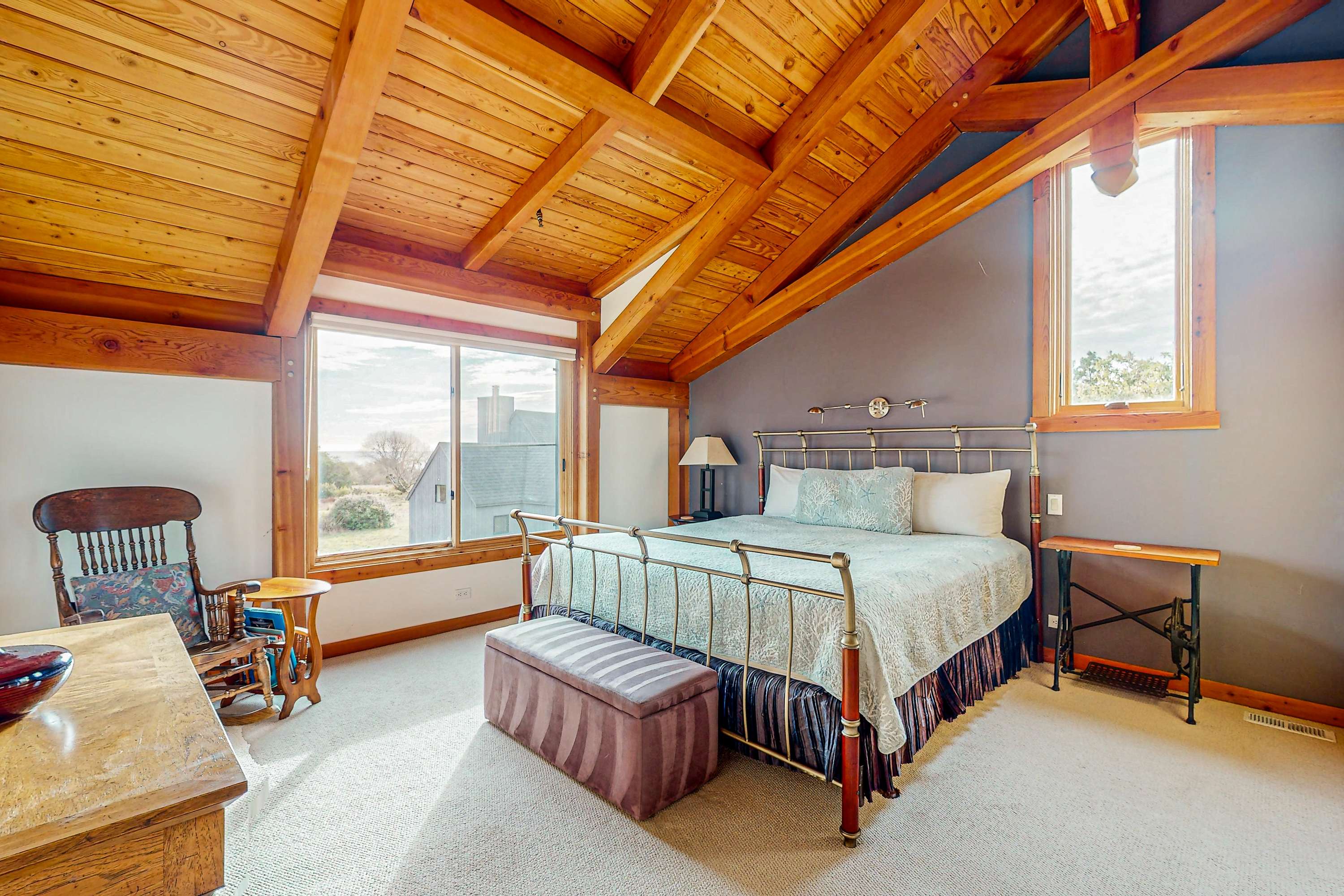 Awake in the master bedroom, where the large windows frame lovely views, inviting morning light and a peaceful start to your day.