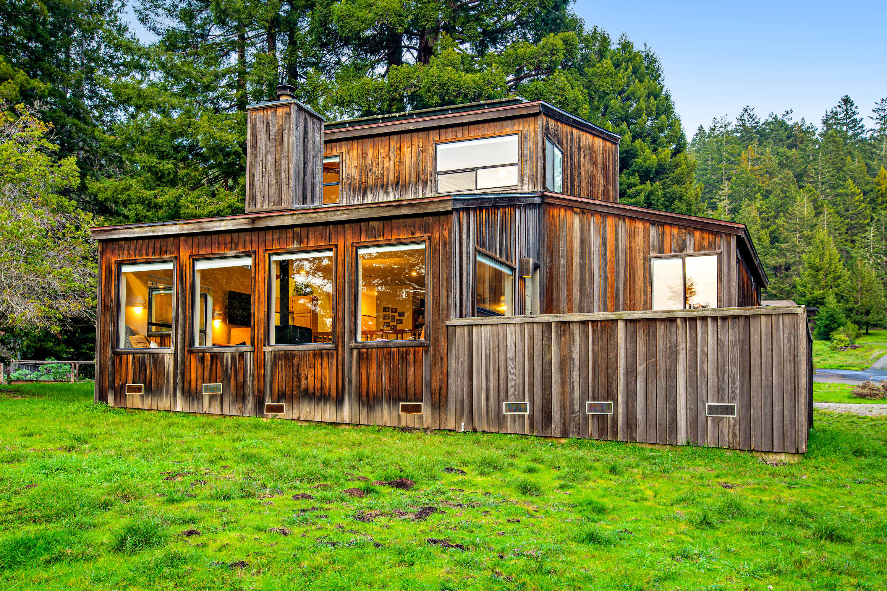The inviting exterior of The Bobcat House showcases its unique character, nestled in nature for a peaceful escape.