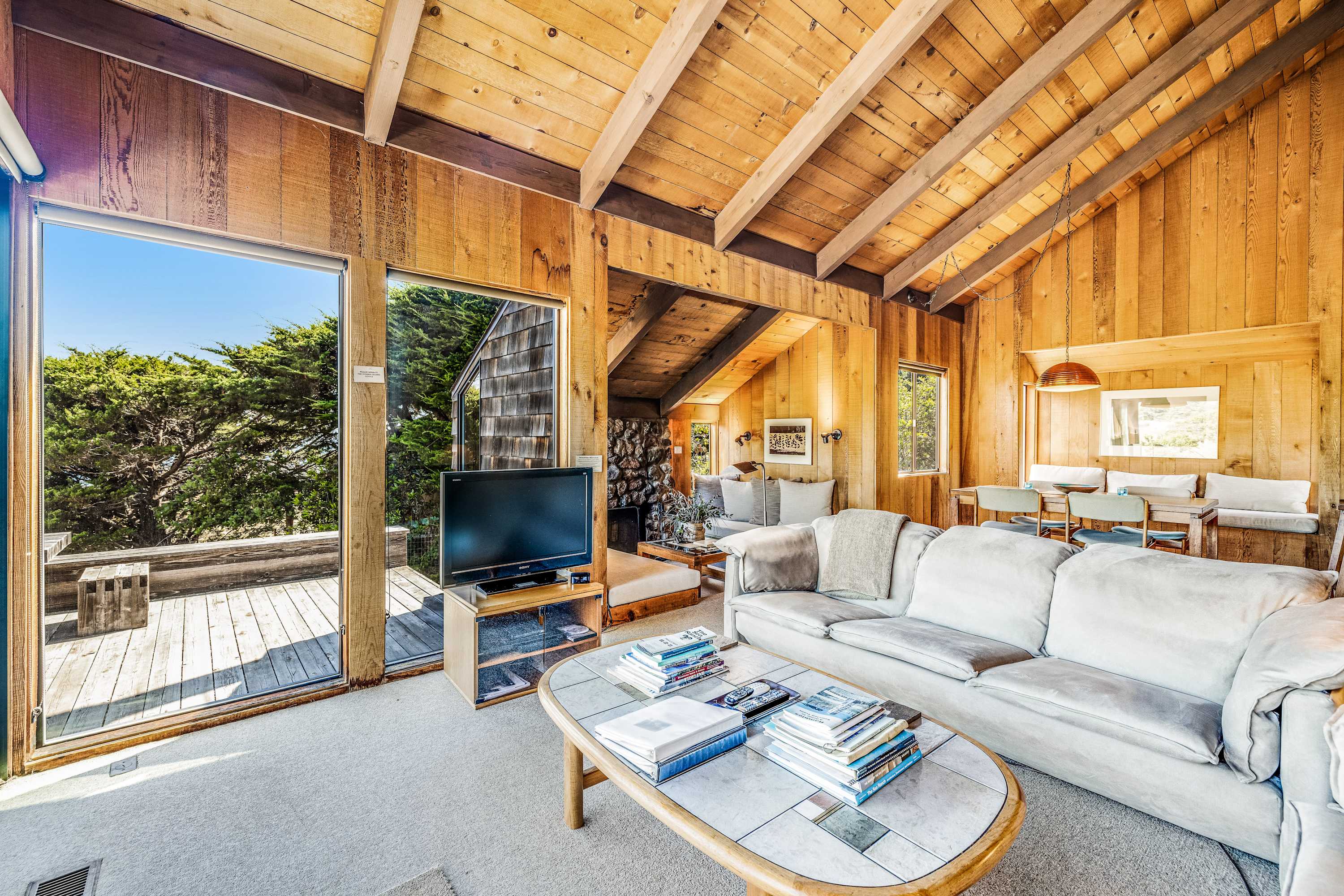 Bask in the warmth of the wood-burning fireplace while enjoying the natural light pouring in from the large windows.