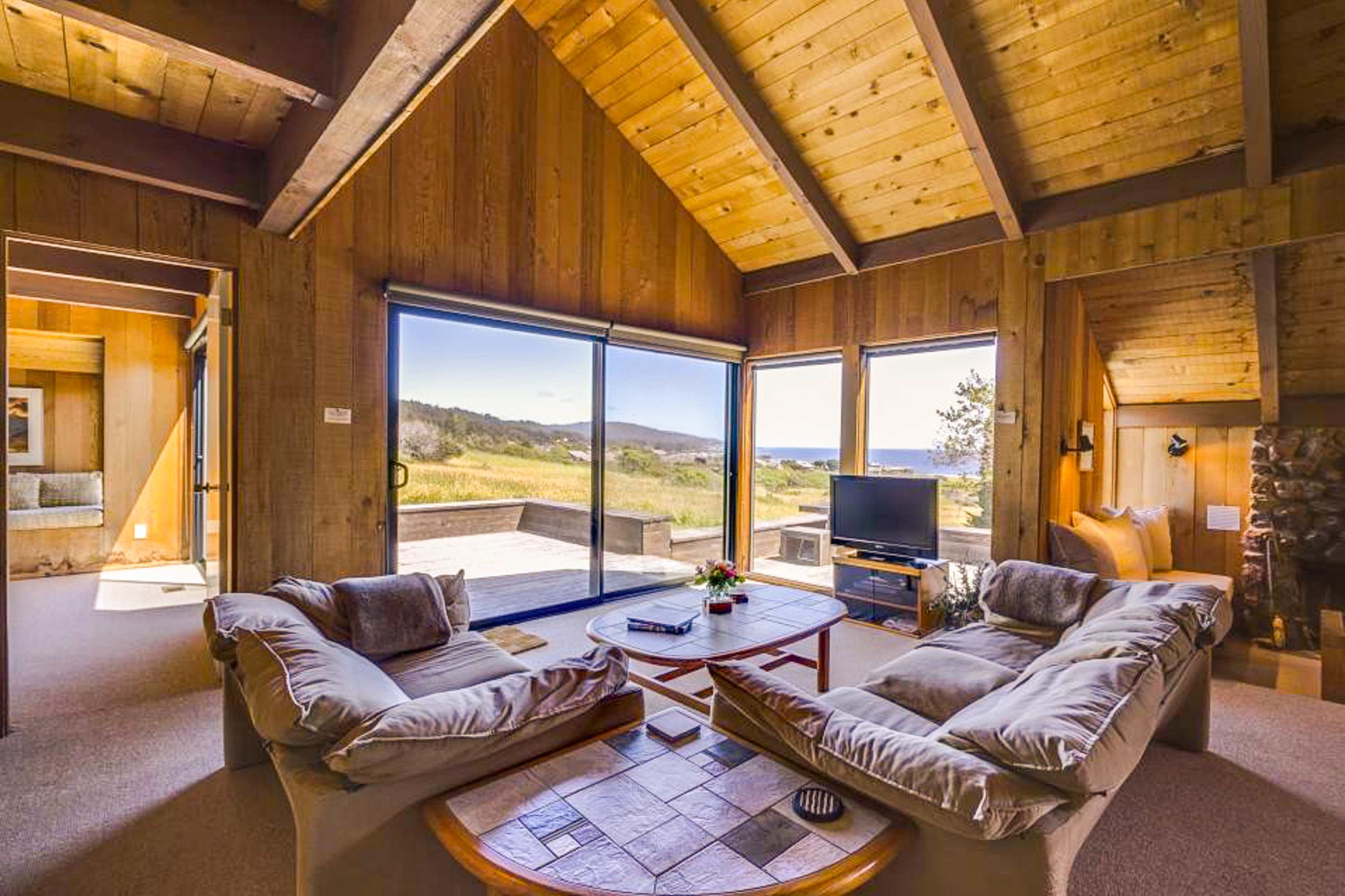 Gaze out at the rolling hills and ocean from this cozy living area, where comfort meets stunning views.