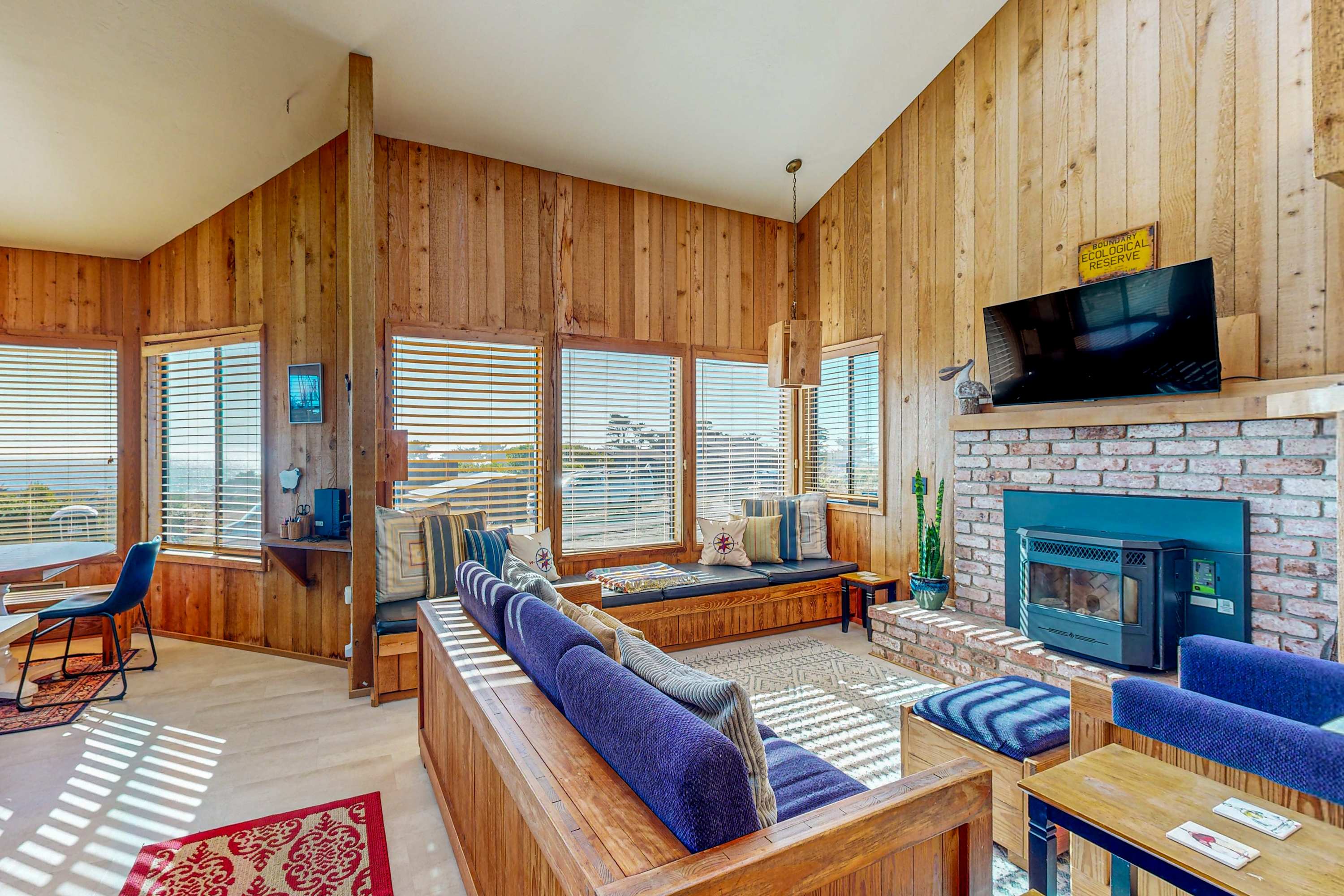 Imagine evenings spent in this cozy living room, where you can gather around the fireplace and enjoy the stunning ocean views through expansive windows.