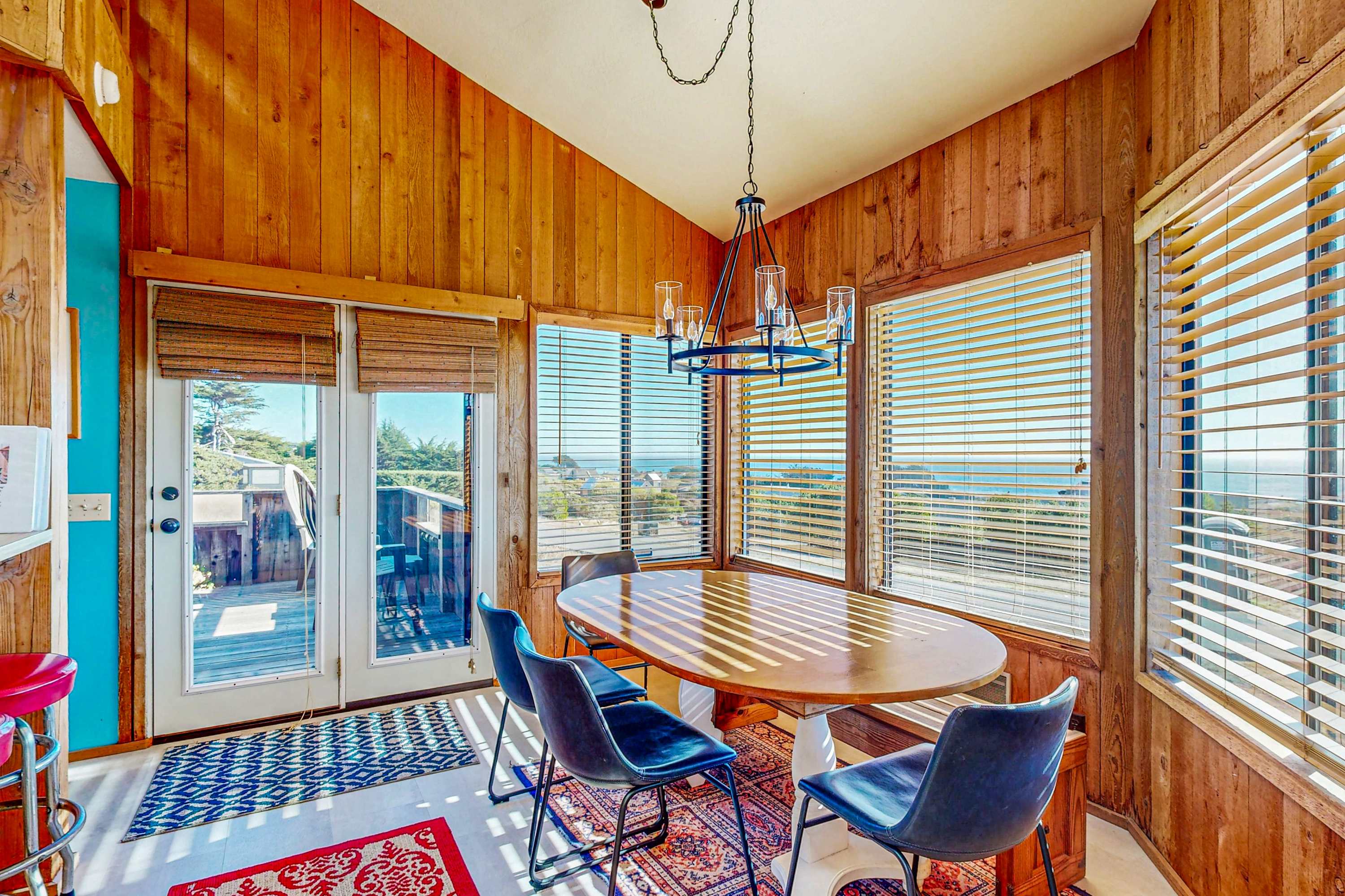 Dine with a view in this charming dining area, where large windows frame the ocean, creating a picturesque backdrop for your meals together.