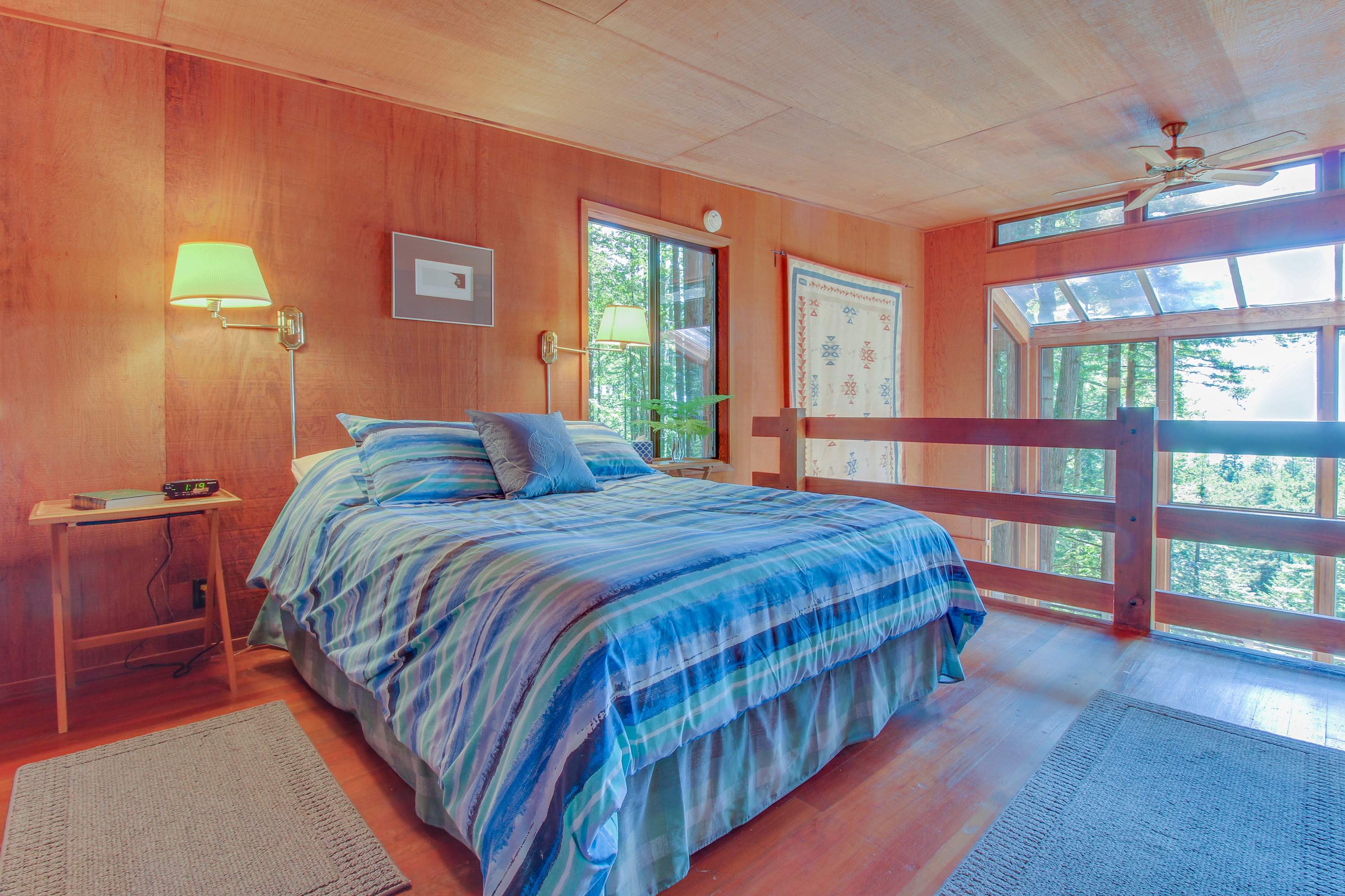 Wake up surrounded by nature in this serene master bedroom, where sunlight dances through the windows and a gentle breeze invites relaxation.