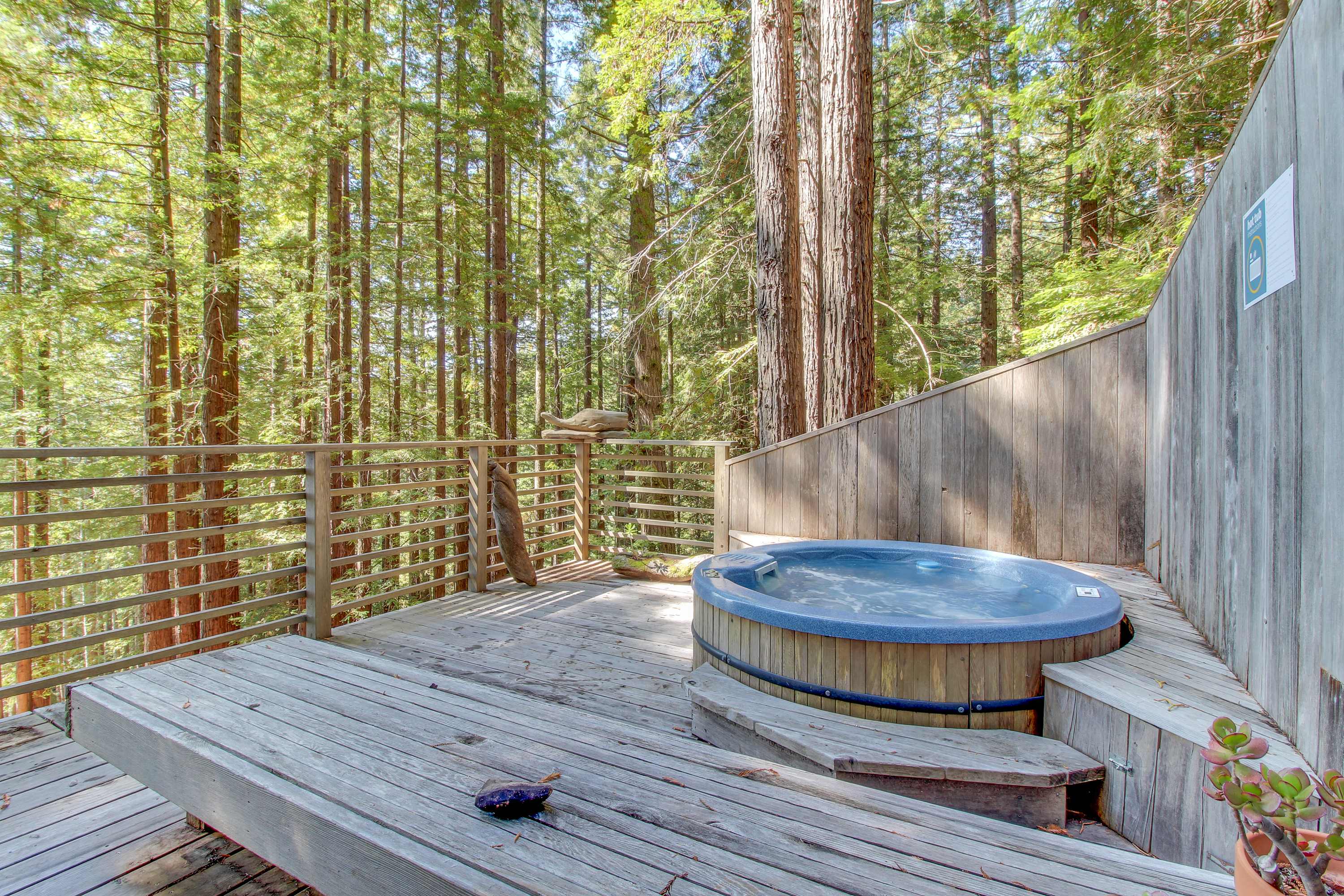 Indulge in relaxation in your private hot tub, nestled among the trees for a truly tranquil experience.