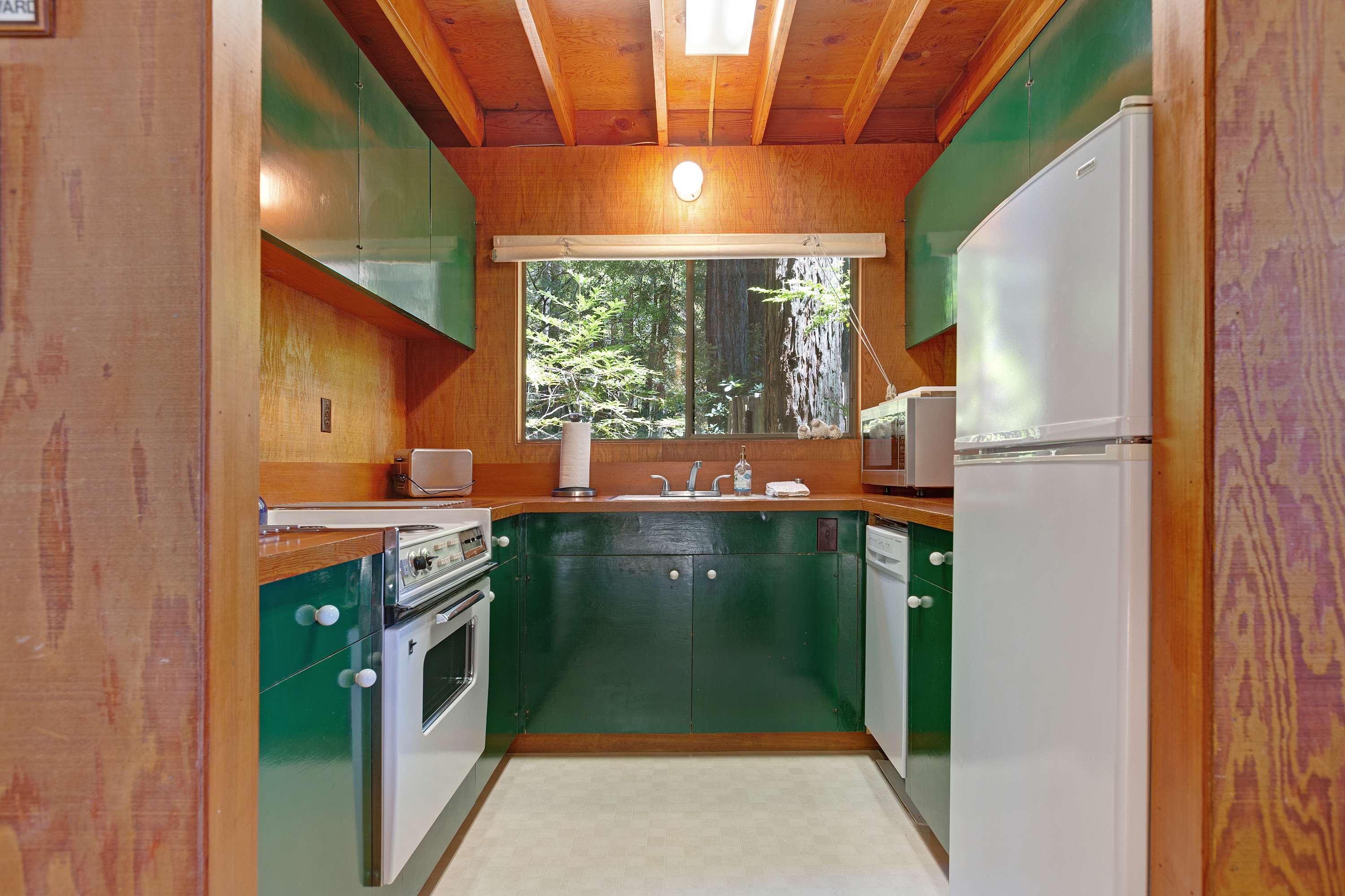Whip up your favorite meals in the well-equipped kitchen, where the vibrant colors and natural light create an inviting space for culinary creativity.