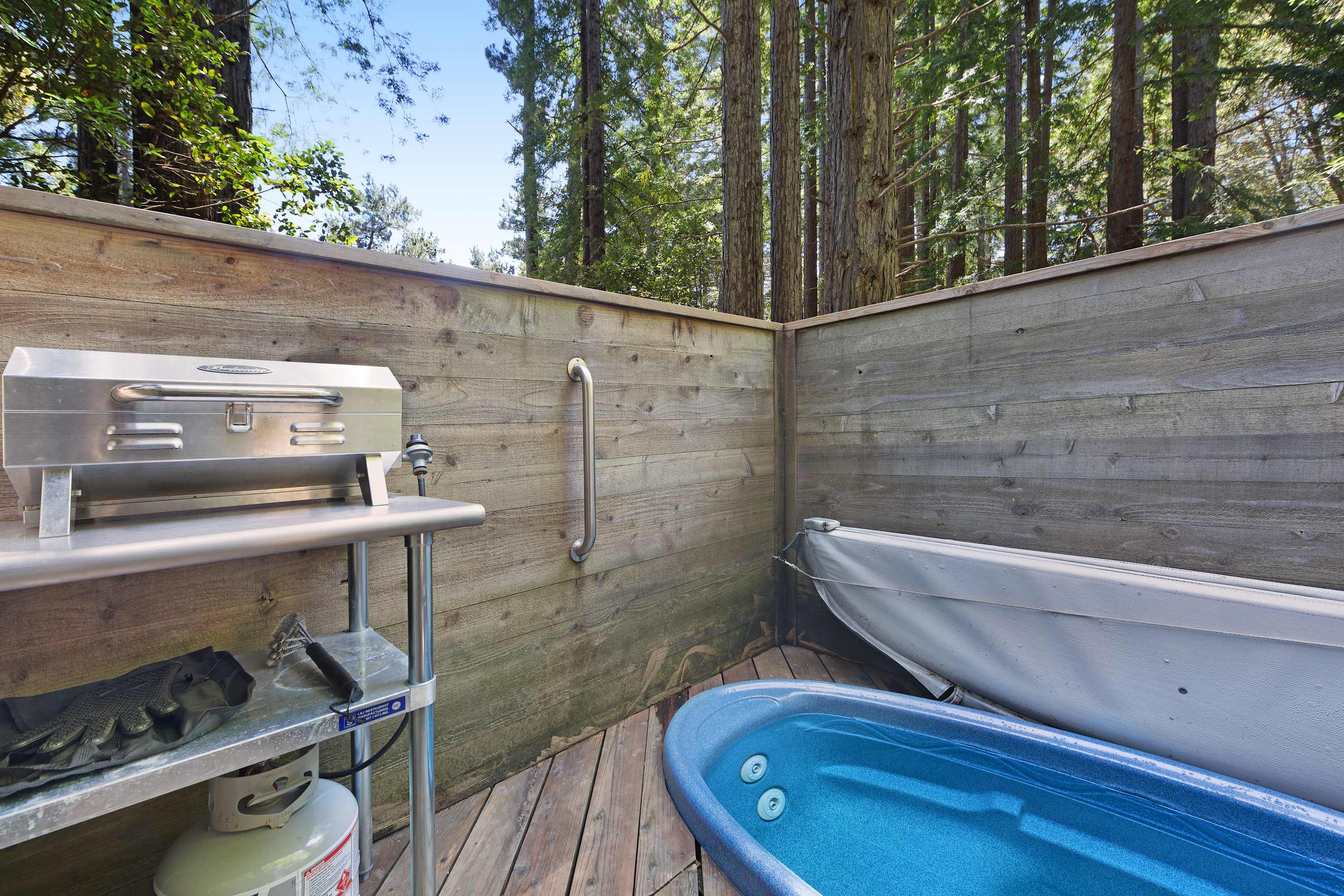 Imagine soaking in the private hot tub, surrounded by towering redwoods, as you unwind under the stars after a day of adventure.