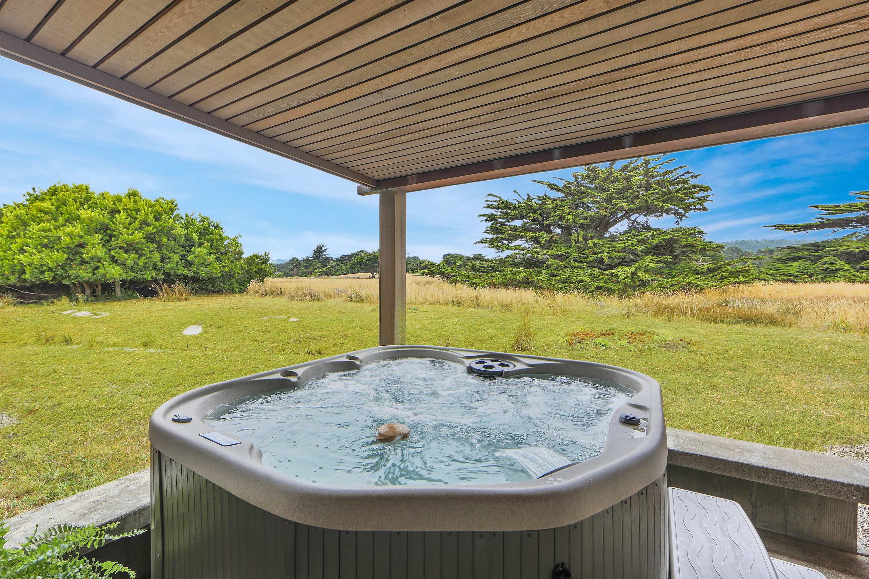 Soak in your private hot tub and let the gentle breeze carry your worries away as you unwind in this peaceful retreat.