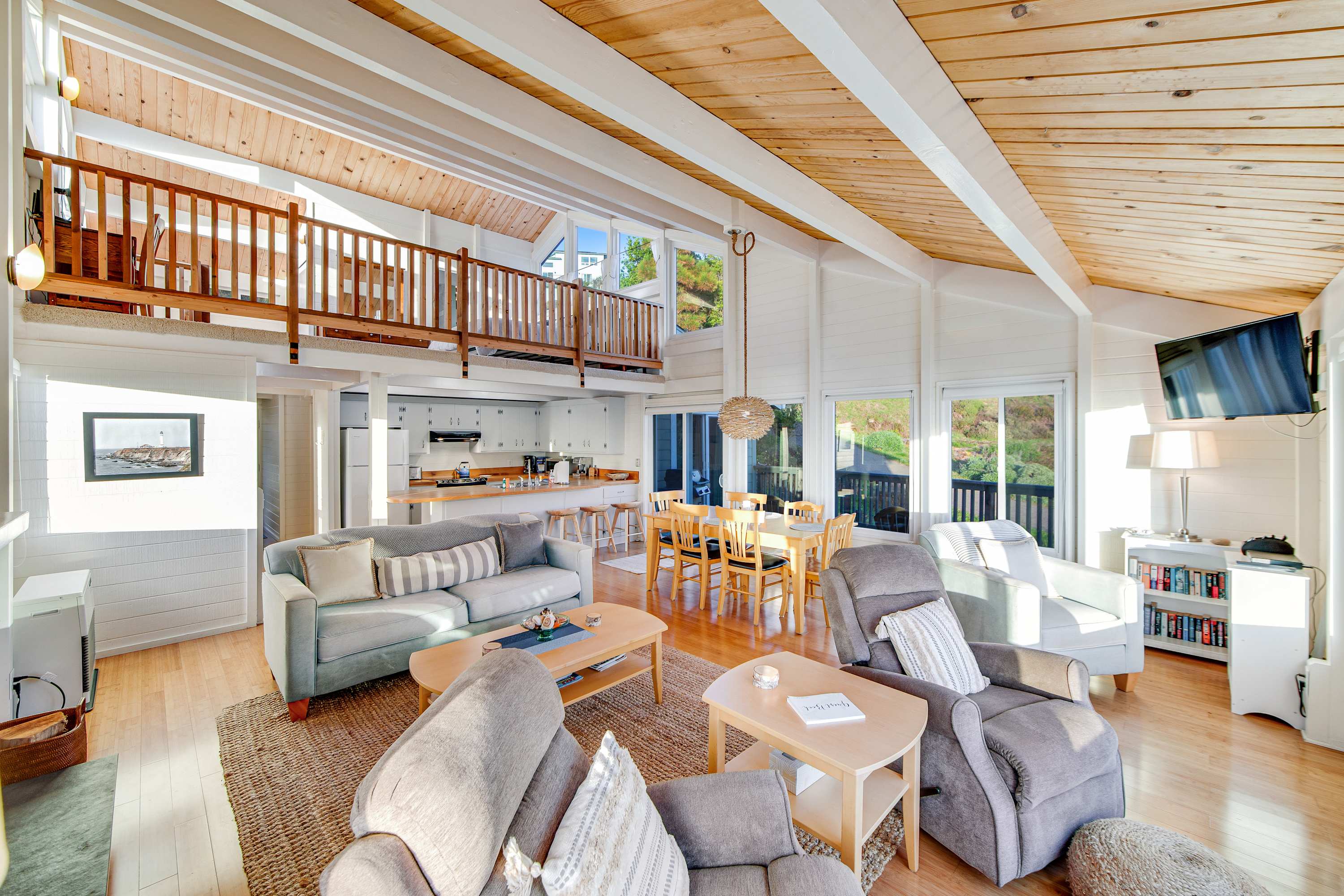 Step into a welcoming space filled with natural light, where you can gather around the wood-burning fireplace after a day of coastal adventures.