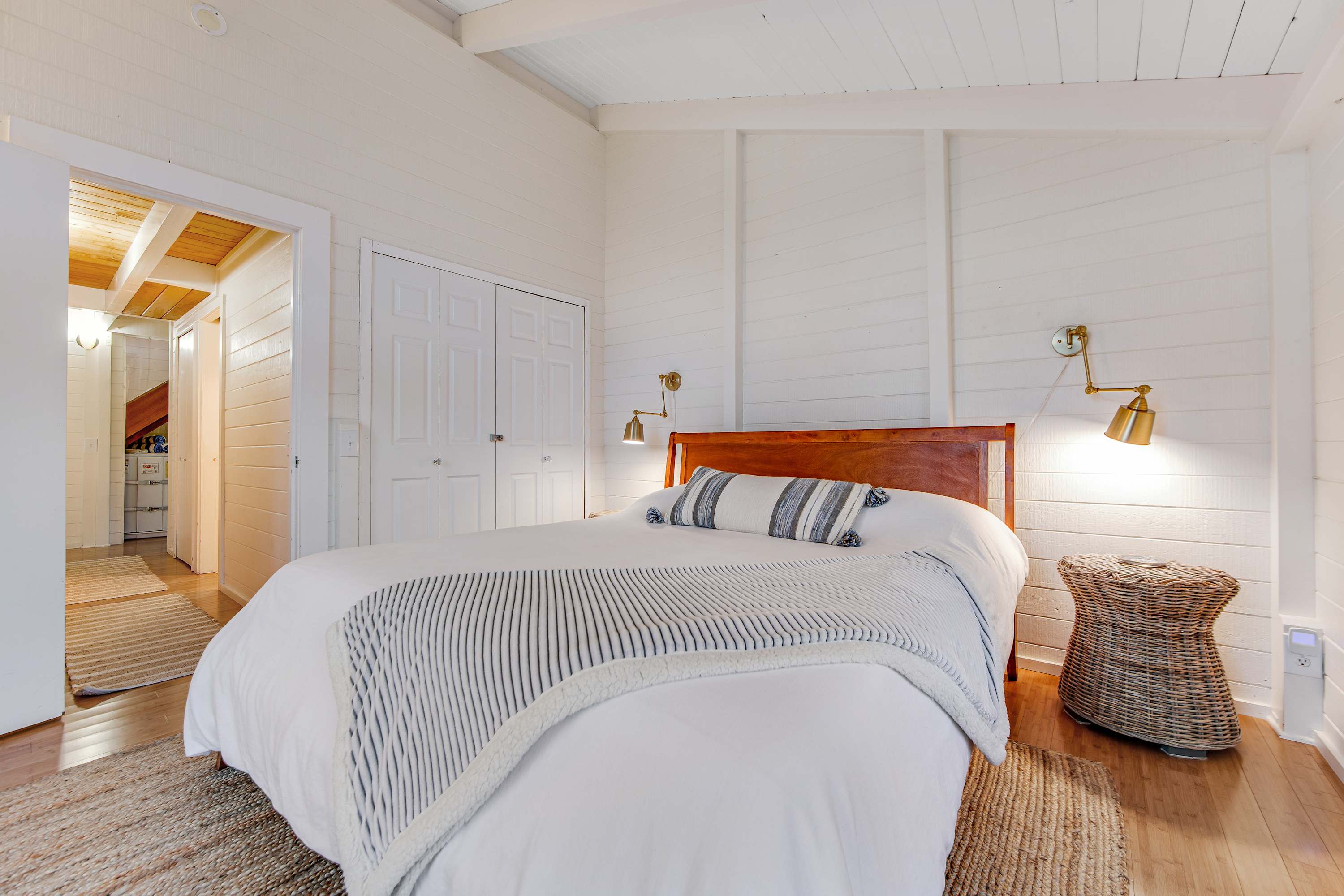 Retreat to the tranquil master bedroom, where soft linens and elegant decor create a peaceful haven after a day by the sea.