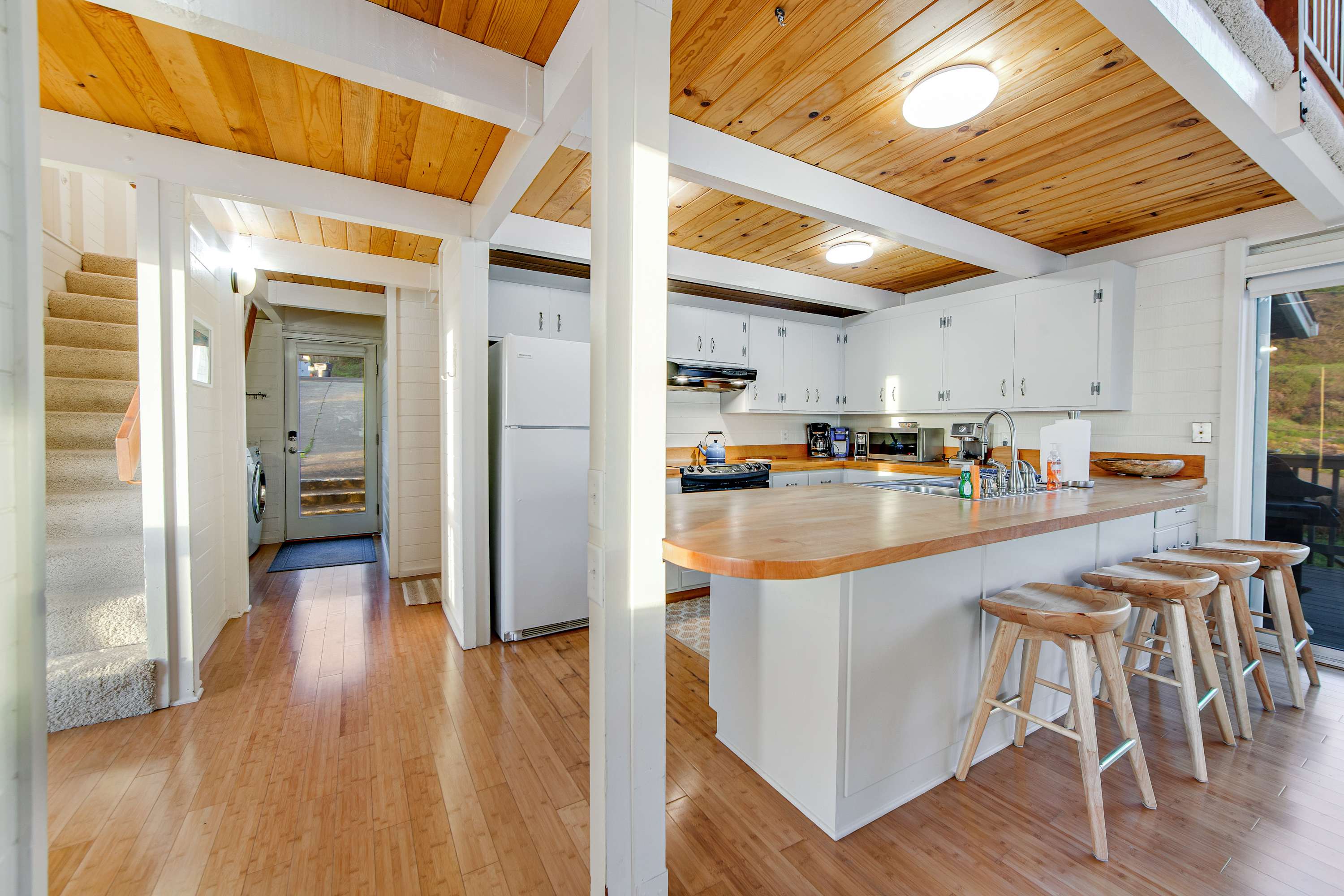Create culinary delights in this spacious kitchen, designed for both cooking and socializing, while enjoying the coastal charm.