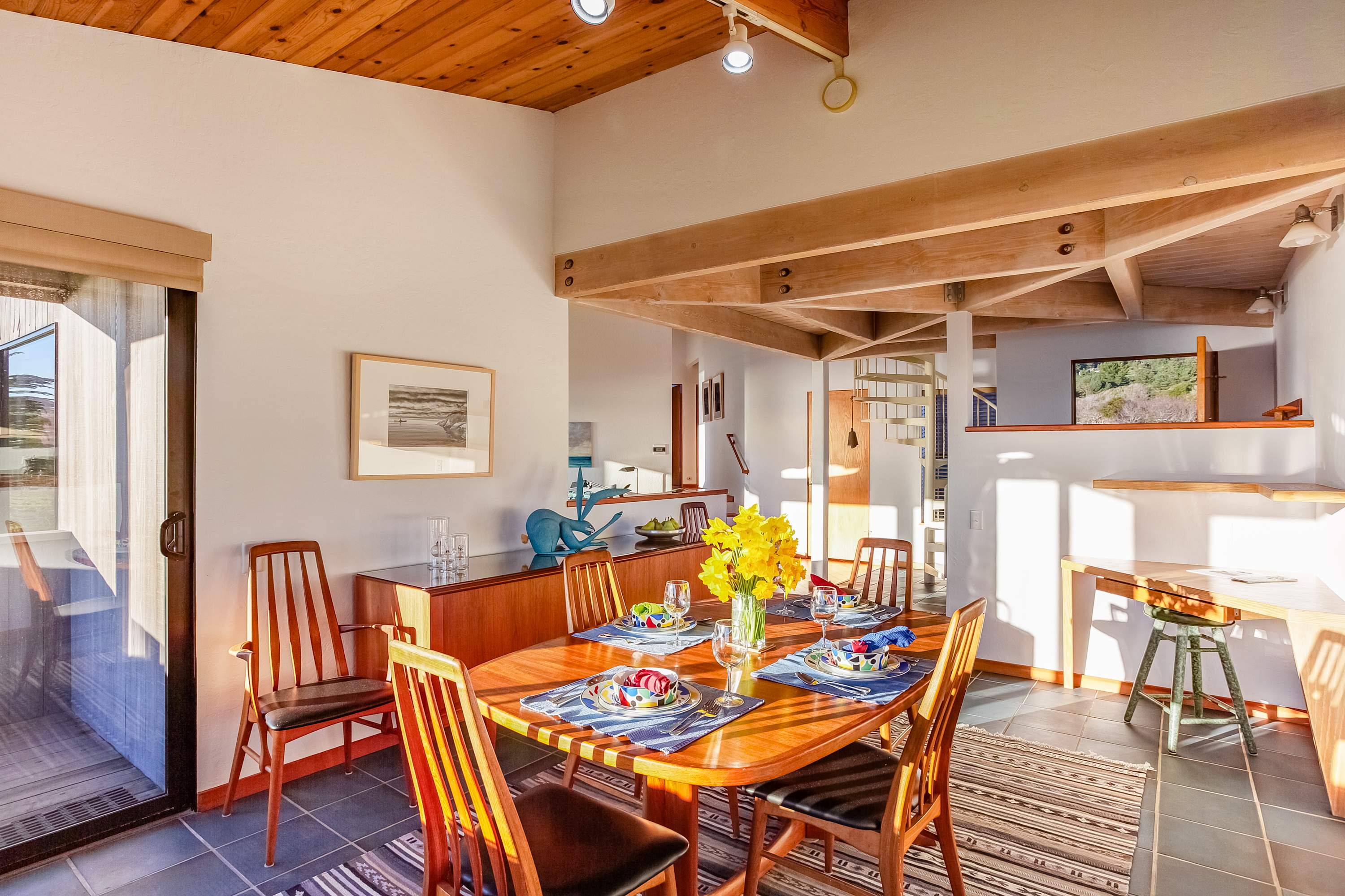 Set the table for a delightful meal in the dining area, where the soft glow of natural light enhances your dining experience with family and friends.
