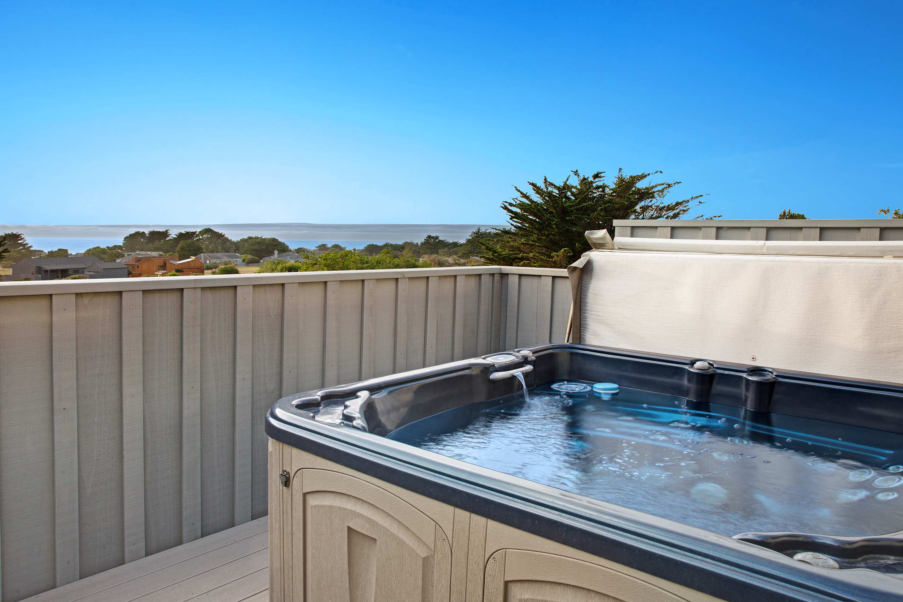 Soak in the bubbles and ocean views from the hot tub, the perfect way to unwind after a day of coastal adventures.
