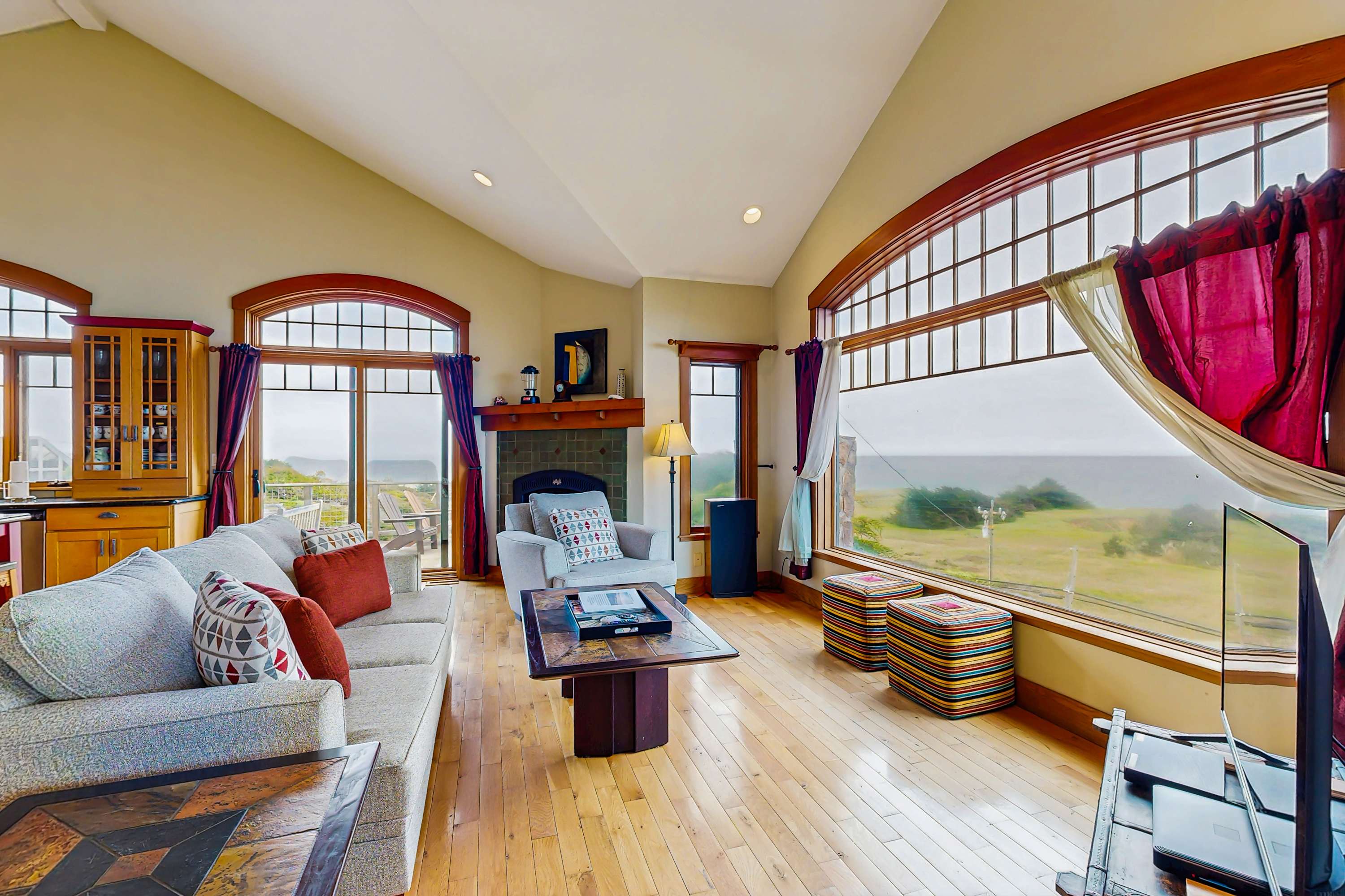 The living room invites you to unwind by the gas fireplace, with large windows framing stunning ocean vistas that change with the tides.