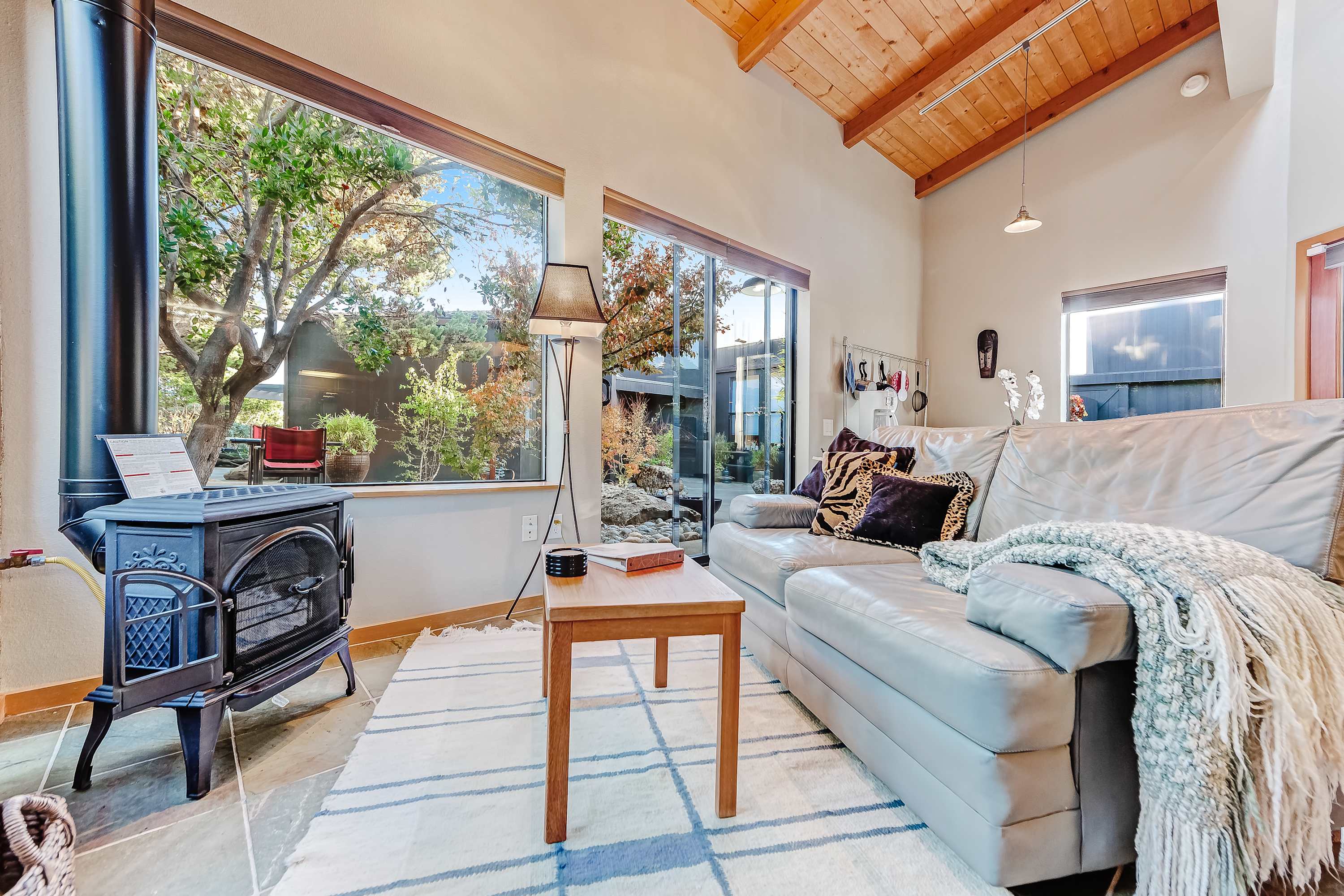 Cozy up by the gas fireplace as natural light pours into the living room, creating a warm and inviting space.