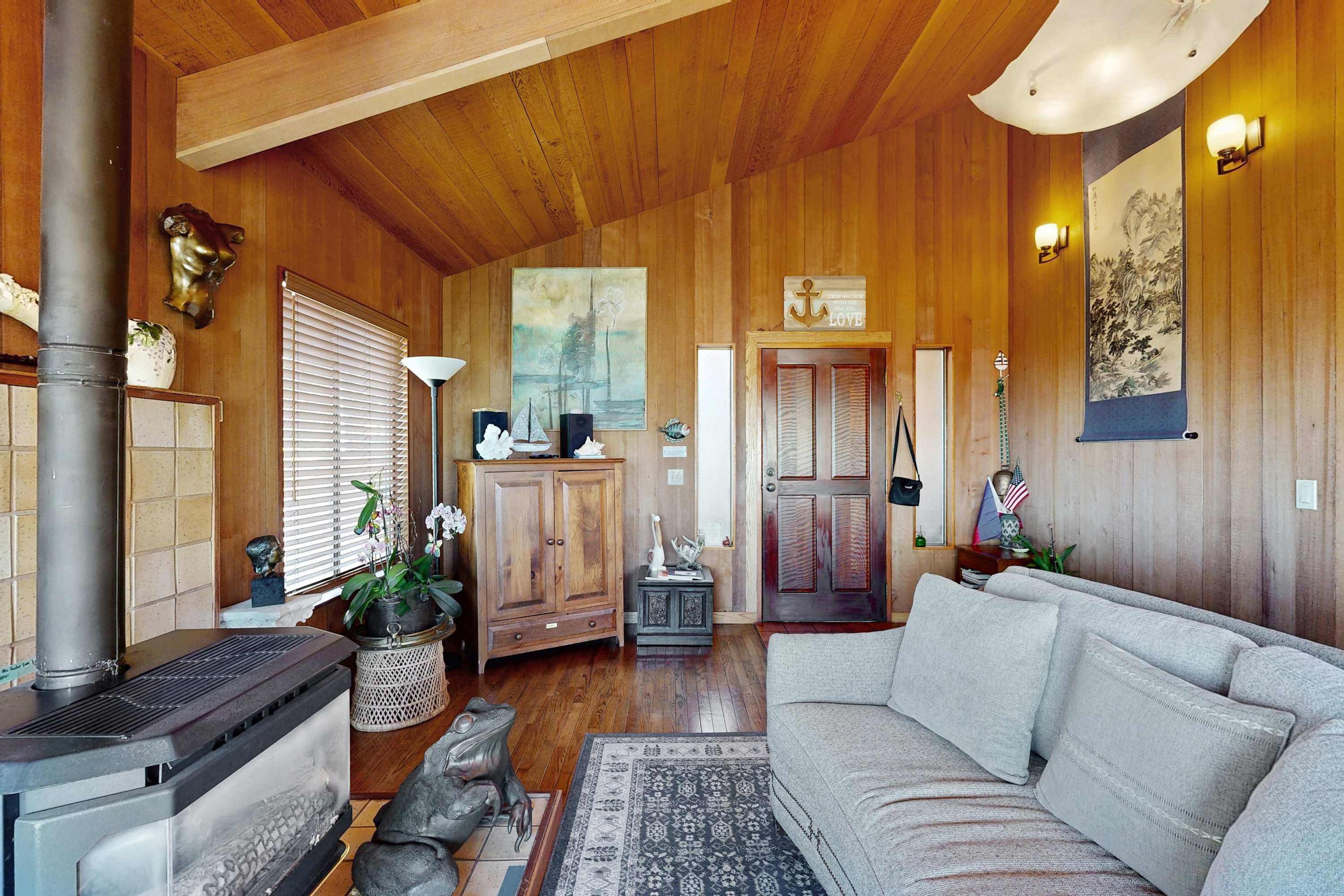 The cozy living room beckons for evenings spent with loved ones, surrounded by natural wood accents and inviting decor.