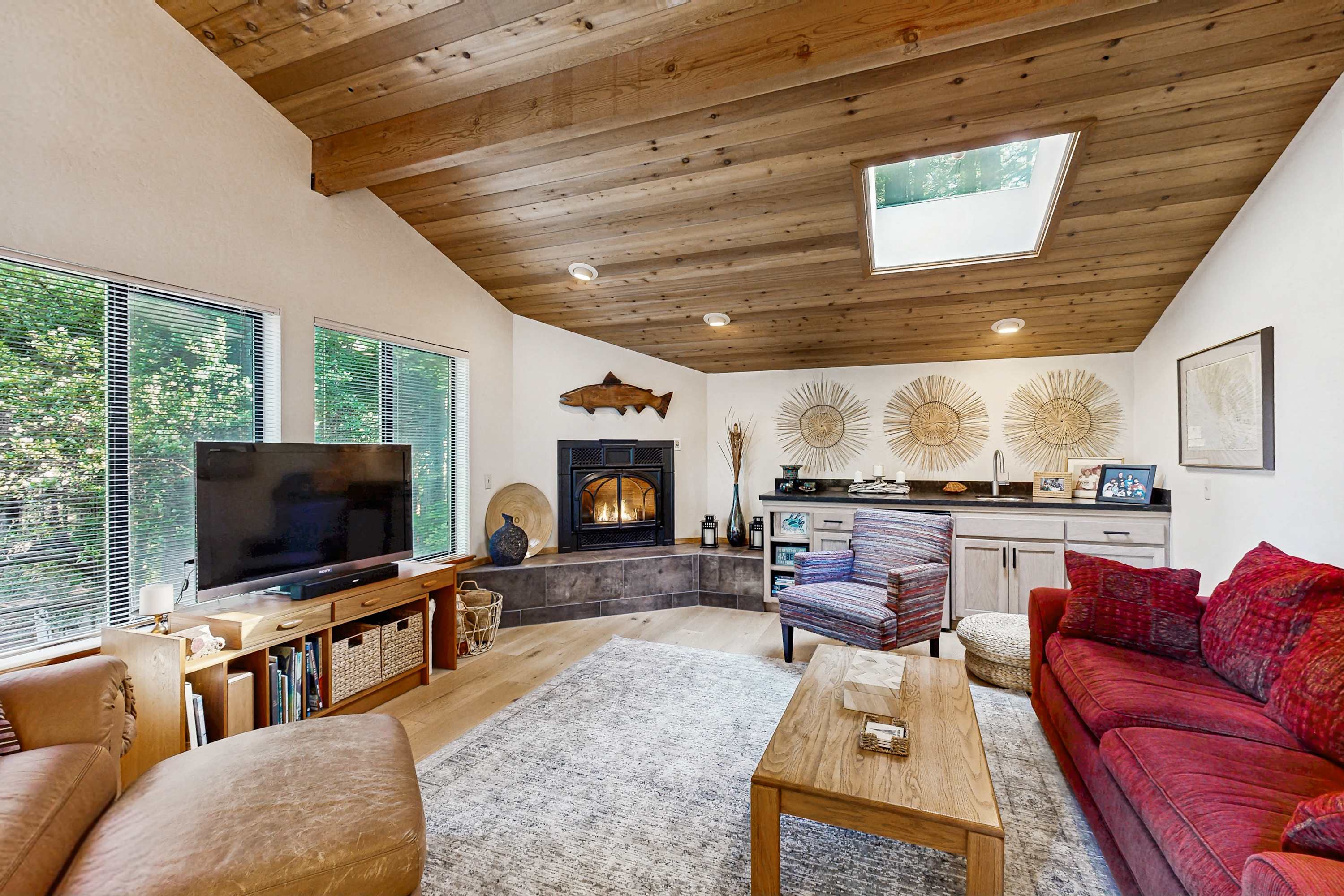 Let the glow of the fireplace and natural light envelop you in this living room, ideal for cozy evenings and casual gatherings.