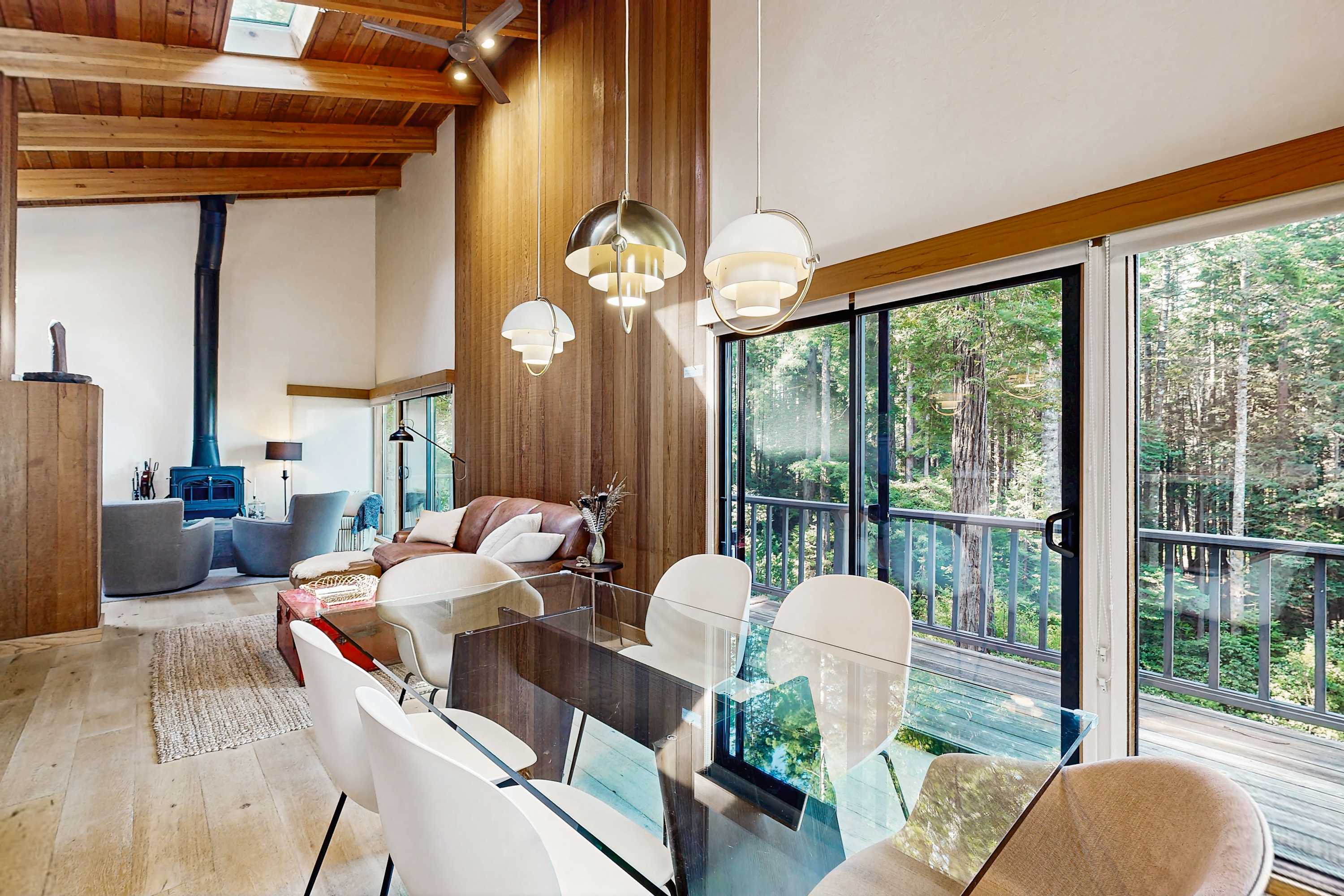 Picture yourself sharing stories over dinner in this bright dining area, seamlessly blending indoor comfort with outdoor splendor.
