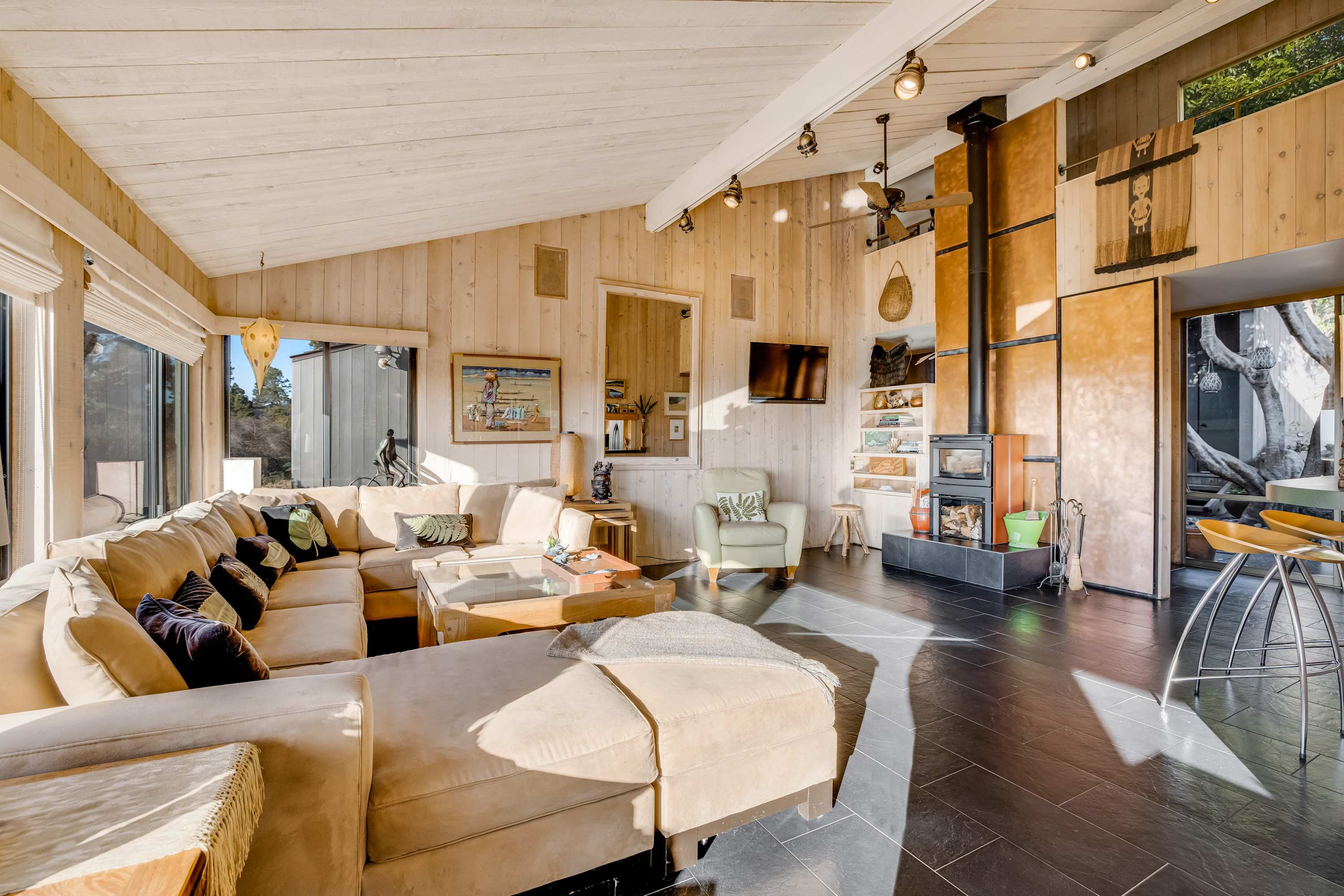 Gather around the cozy fireplace in the bright living room, where ocean views and inviting decor create the perfect space for relaxation.