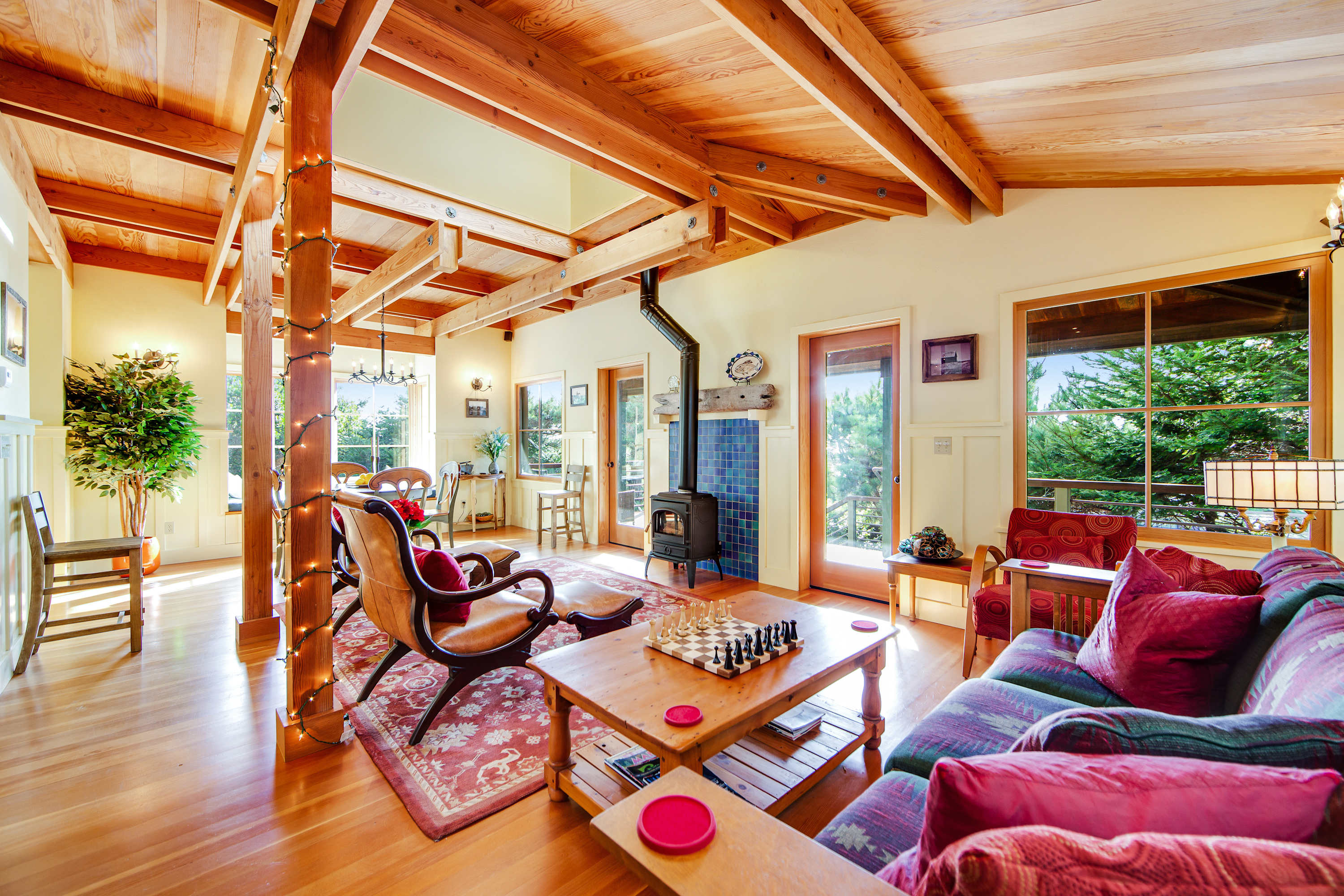 Greet the day in a sunlit living space where ocean breezes flow through large windows, inviting you to relax with a good book.