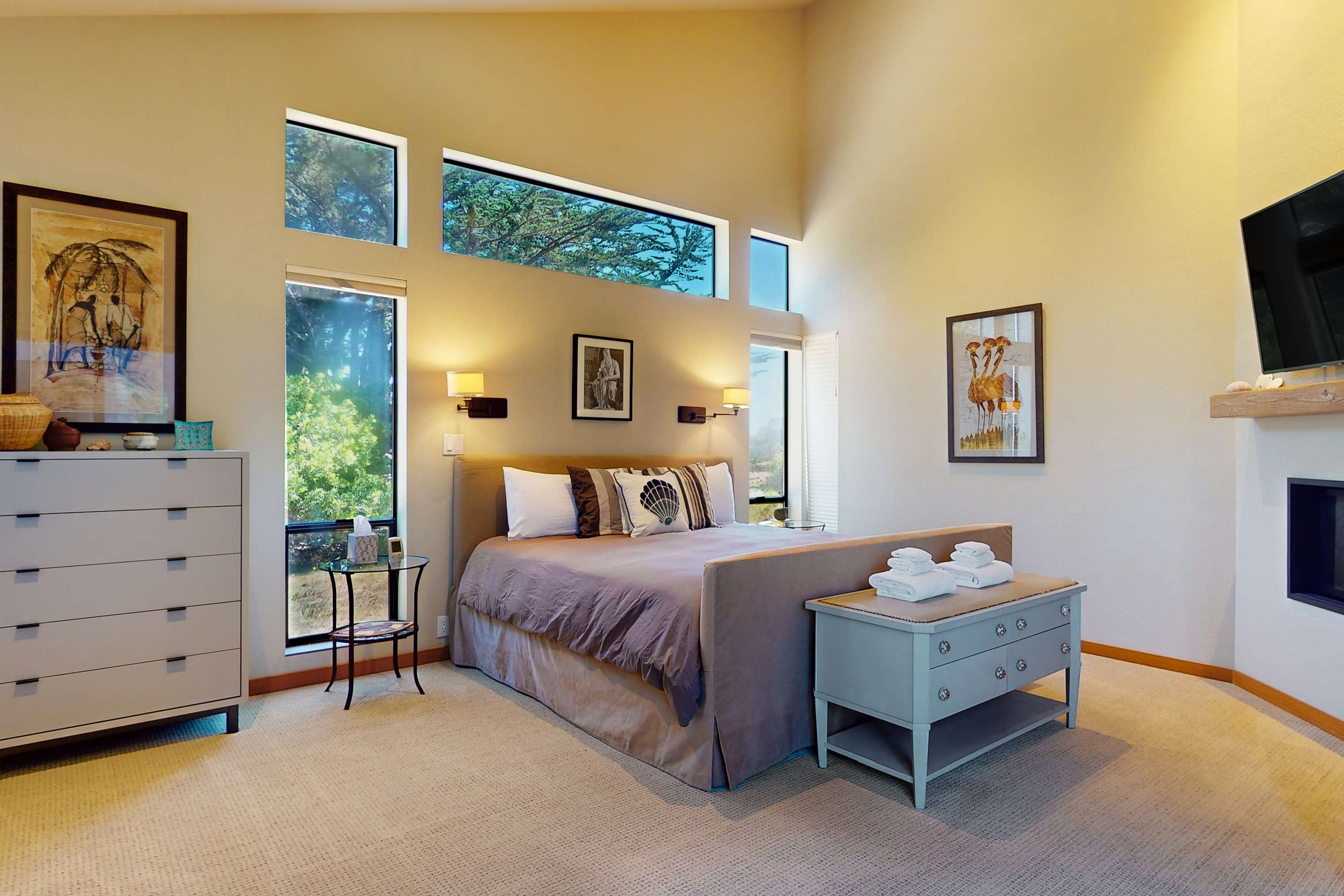 Your serene escape awaits in this master bedroom, where natural light and plush bedding promise restful nights after coastal adventures.