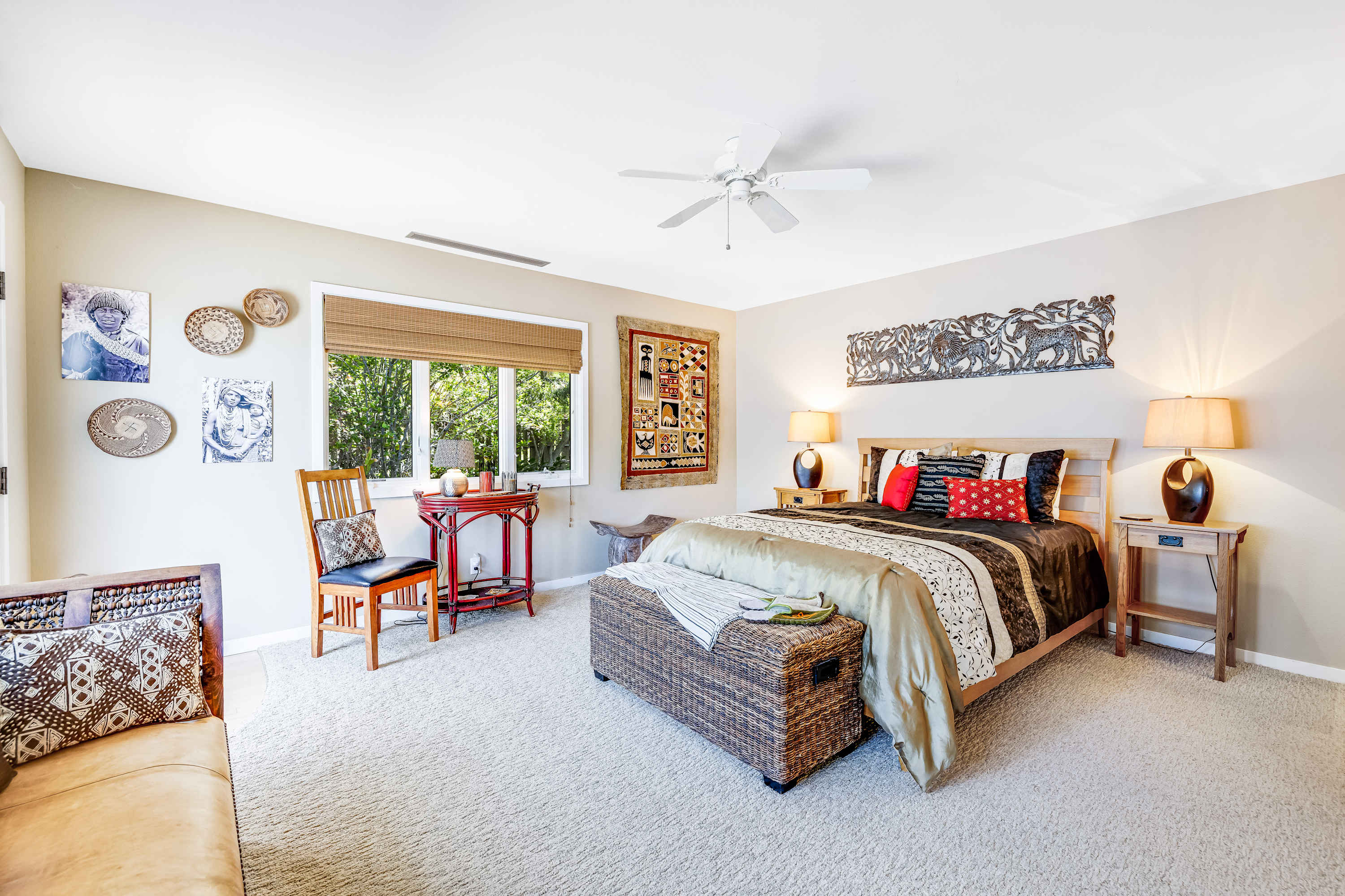 This inviting master bedroom invites you to relax with its tasteful decor and cozy reading nook, perfect for unwinding after a long day.