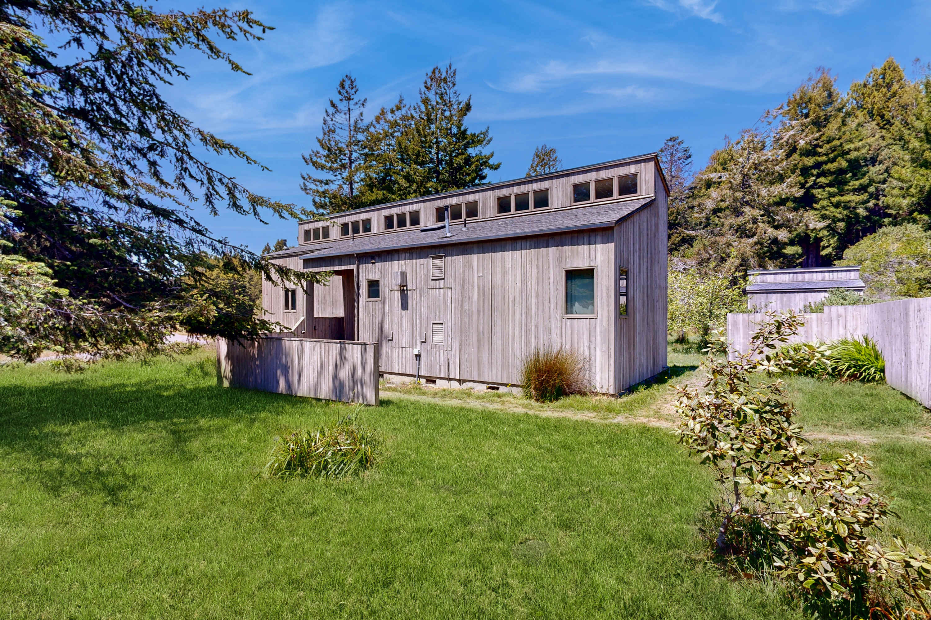 Nestled in lush greenery, Loon's Landing welcomes you with its charming exterior, inviting you to explore the serene beauty of Sea Ranch.