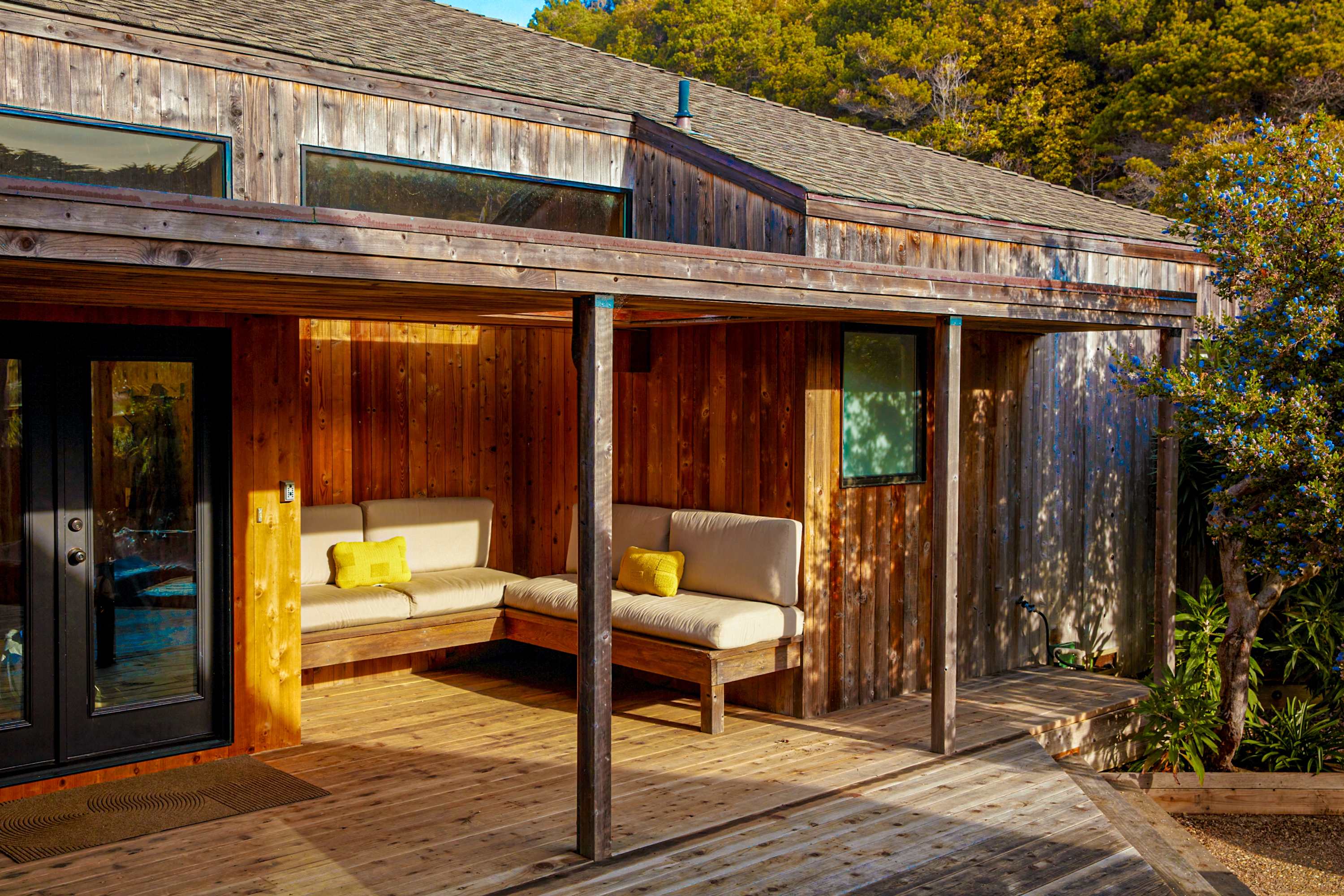 Unwind in your outdoor sanctuary, where cozy seating invites you to sip morning coffee amidst the beauty of nature.