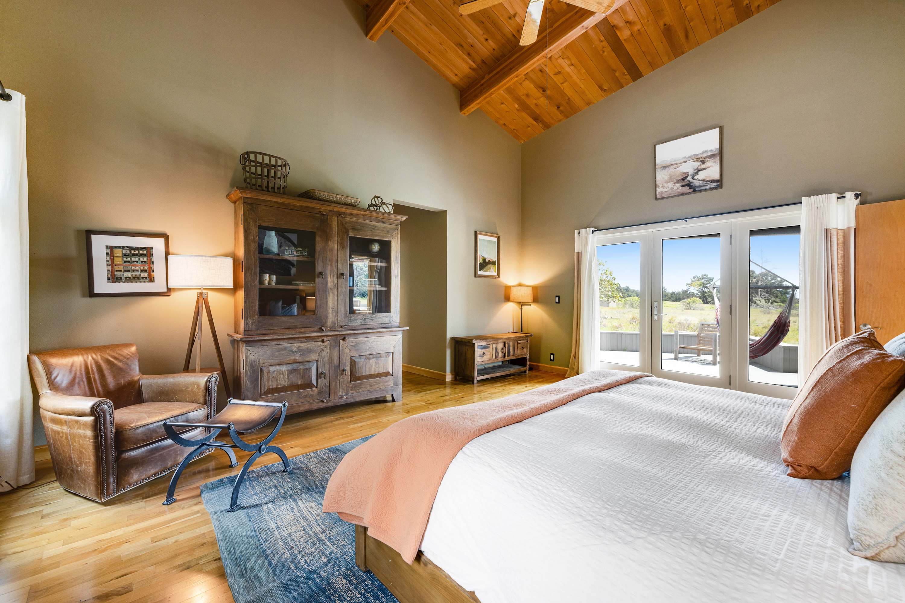 Feel at home in this stylish master bedroom, where high ceilings and rich textures create a warm and welcoming retreat.