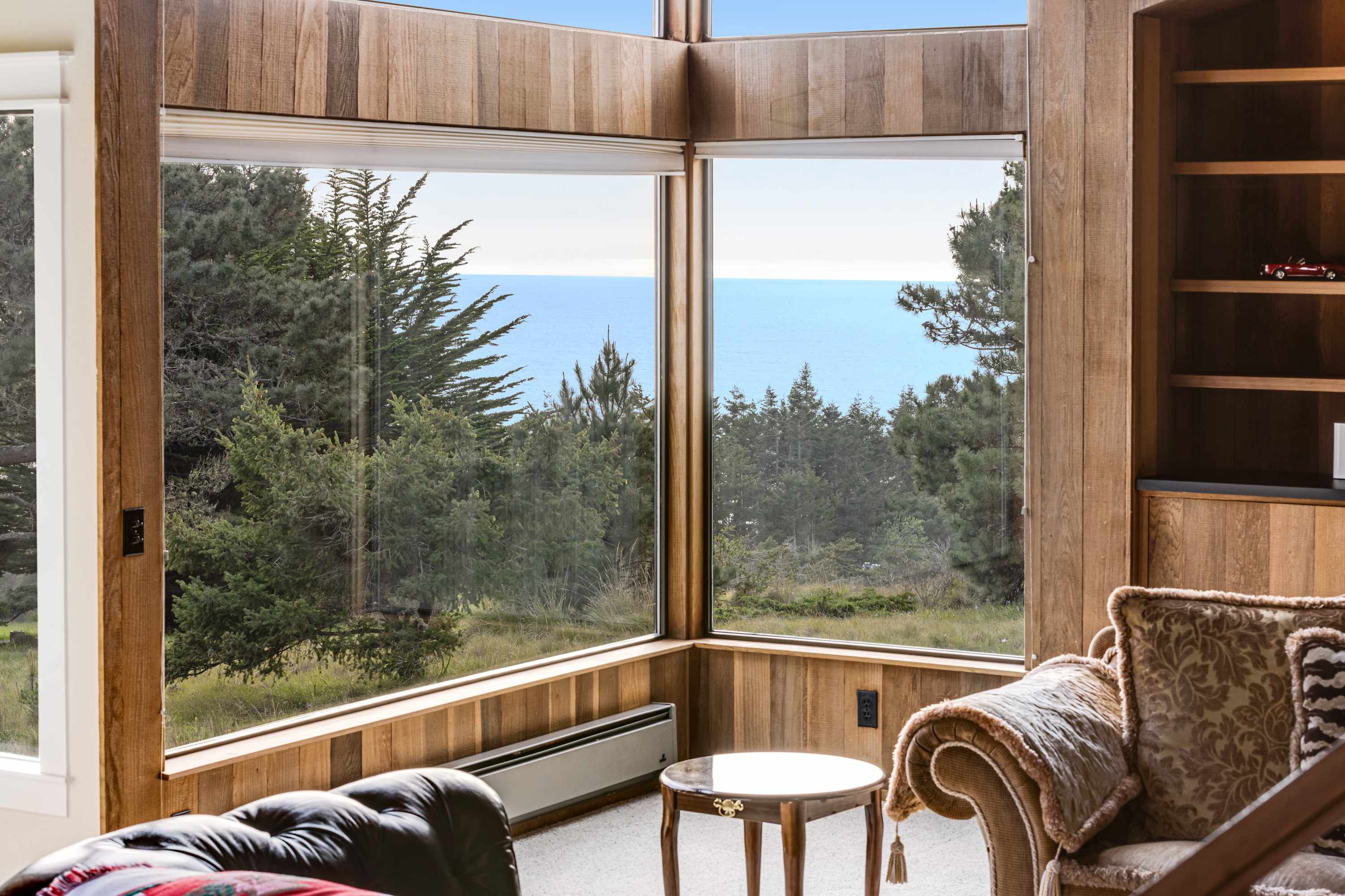 Bask in the glow of the wood-burning fireplace while soaking in breathtaking ocean views through floor-to-ceiling windows.